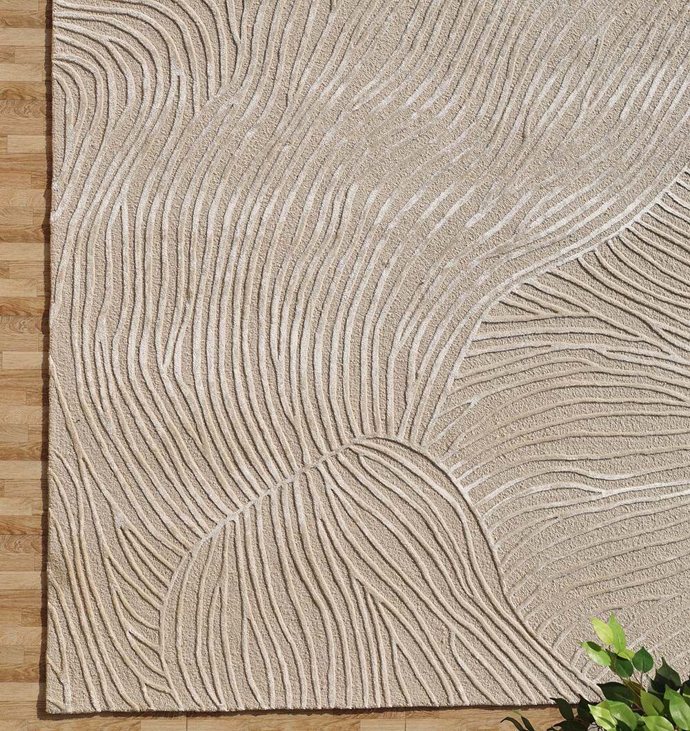 The RAMSHA HOME Natural White Color Handmade Area Rug - HTWV-143 (300x400 cm) adds depth with its textured, abstract design on a wooden floor, while a green leafy plant appears in the bottom right corner.
