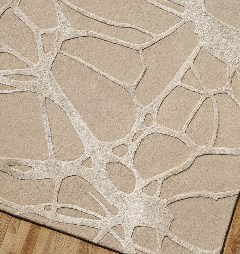 The RAMSHA HOME Natural White Color Handmade Area Rug (HTWV-145, 200x300 cm) features abstract, interconnected shapes on a beige base for a modern look, perfectly complementing wooden floors.