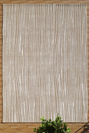The RAMSHA HOME Natural Color Handmade Area Rug (HTWV-147, 300x400 cm) features a beige and cream wood-grain stripe pattern, shown on a wooden floor with a green leafy plant partially visible at the bottom.