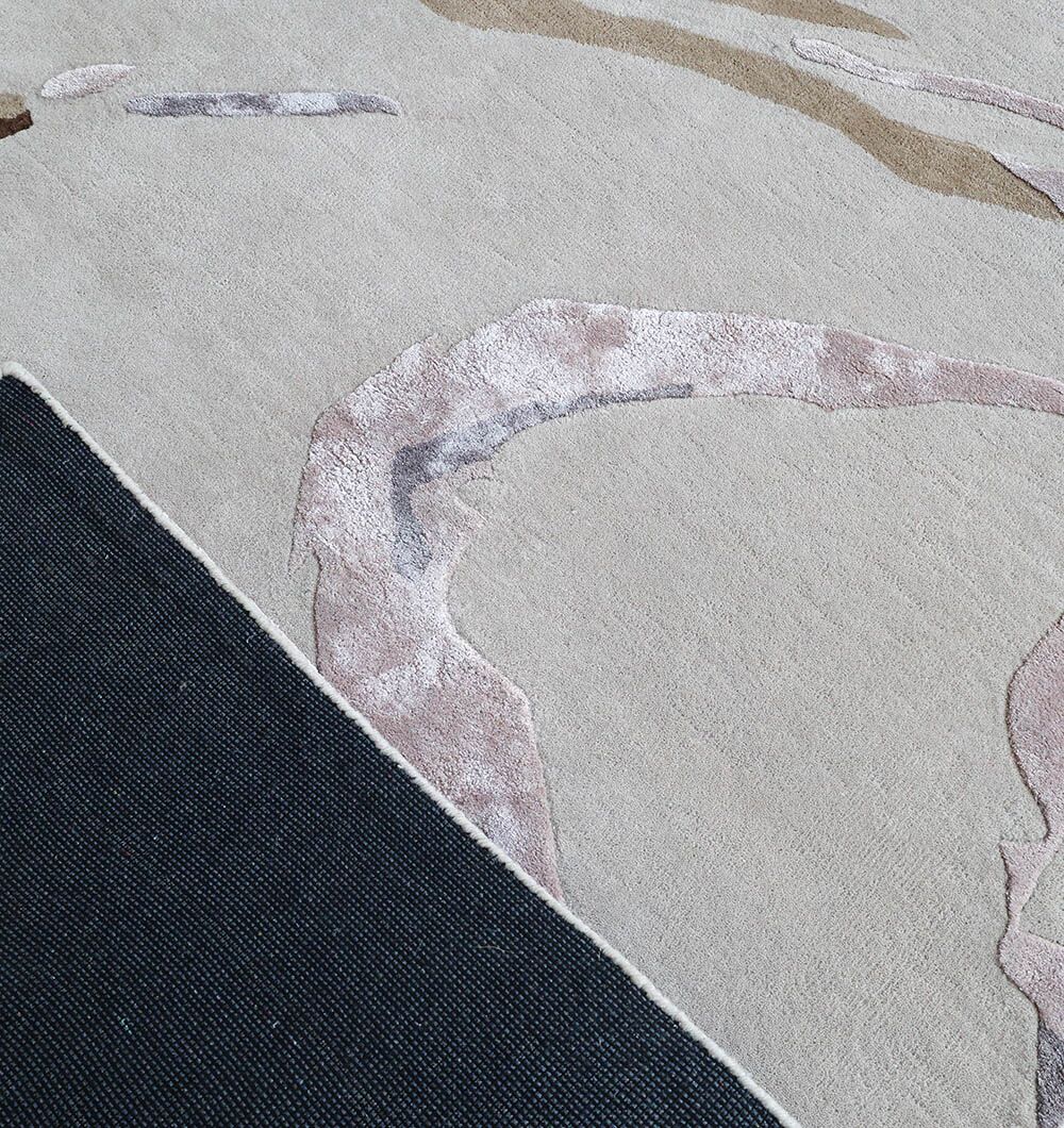 A close-up of the RAMSHA HOME Multi Color Handmade Rug - HTWV 158 (300x400 cm) shows its textured, wavy patterns in beige, pink, and taupe. A black rug underlay at the corner highlights the modern abstract style.