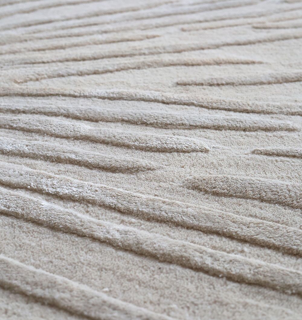 Close-up of RAMSHA HOME Rectangle Home Decor Light Beige Rug - HTWV 160 (300x400 cm), featuring a hand-tufted texture with raised, uneven lines that create a subtle striped pattern across its beige surface.