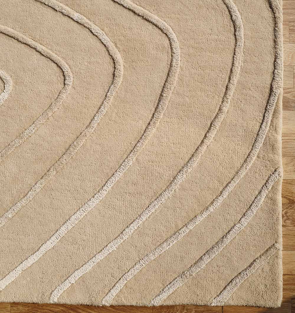 The RAMSHA HOME Beige Color Handmade Decorative Area Rug - HTWV 161 (300X400 cm) features textured, curved lines in a concentric pattern and is shown on a light wooden floor.