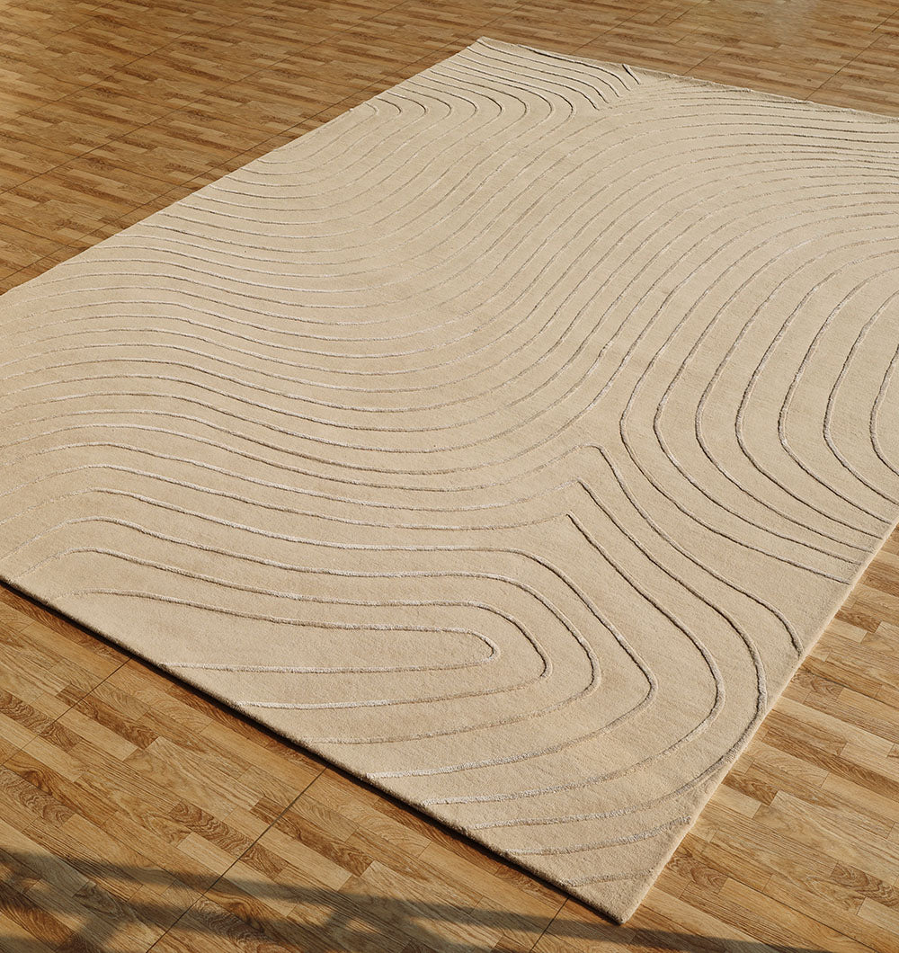 The RAMSHA HOME Beige Color Handmade Decorative Area Rug - HTWV 161 (300x400 cm) features raised, wavy lines forming an abstract pattern, displayed on a wooden parquet floor.