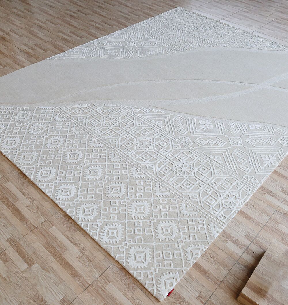 The RAMSHA HOME Boho Geometric Handmade Decorative Area Rug - HTWV 167 (300X400 cm) in cream and beige, featuring tribal patterns, is displayed on a light wood floor in a spacious room.