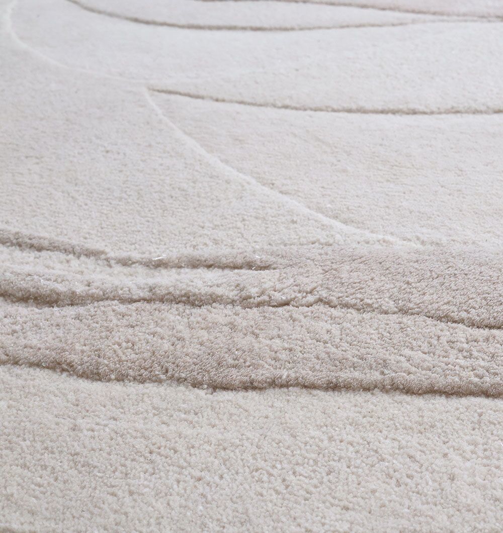 A close-up of the RAMSHA HOME Decorative Area Handmade Rug - HTWV 169 (200 cm) highlights its textured beige and cream tones, raised wavy patterns, and soft, plush fibers.