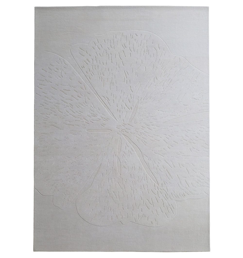 The RAMSHA HOME Embossed Floral Solid Light Grey Rug – HTWV 171 is a rectangular, light-colored wool-viscose rug with a refined textured floral pattern featuring subtle petal and stamen details.