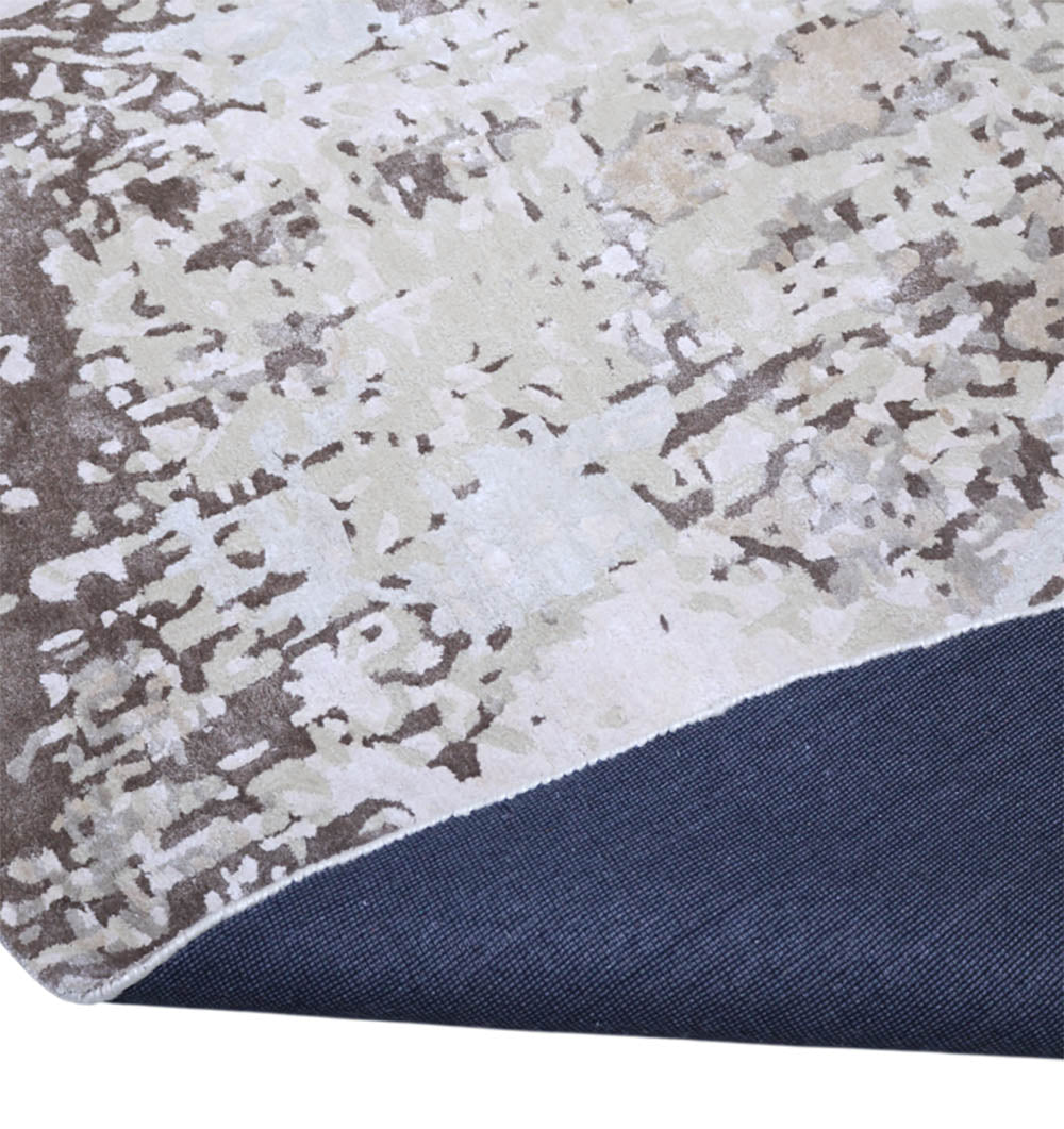 A close-up of the RAMSHA HOME Round Wool Handmade Carpet 350 cm in neutral tones (HTWV-173), with one corner folded to display its dark blue non-slip backing.