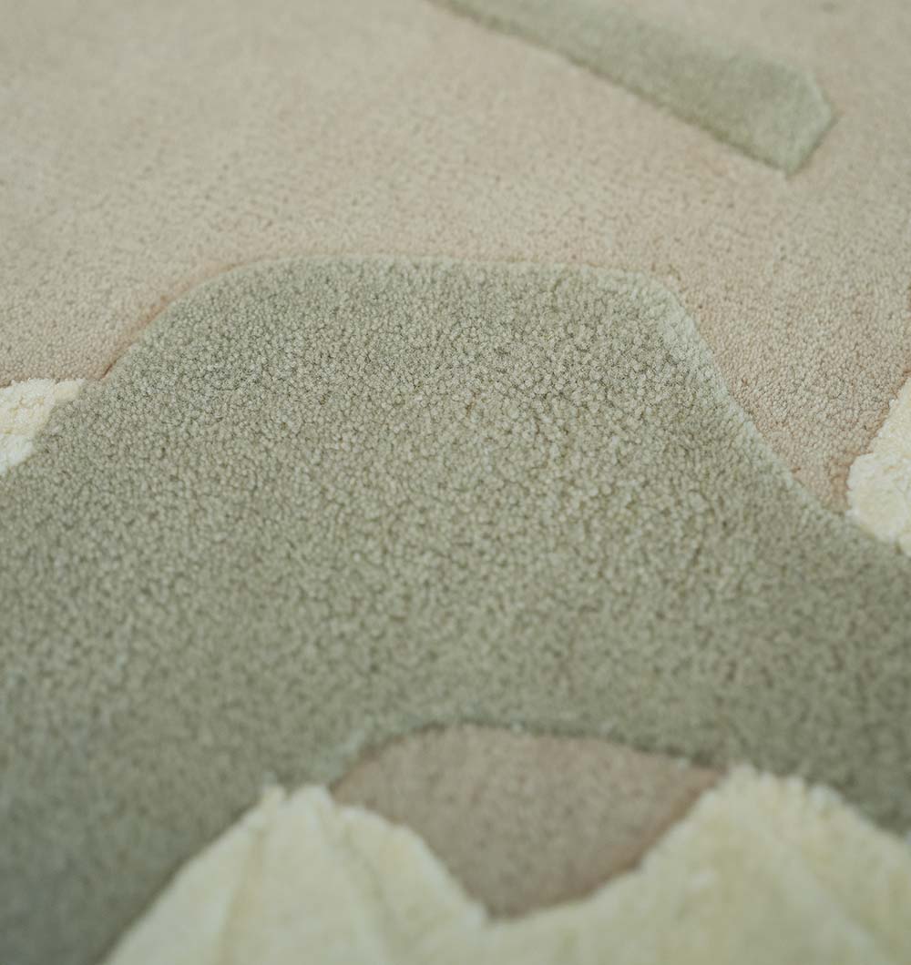 Close-up of the RAMSHA HOME Abstract Wool & Viscose Handmade Carpet 300x400 – HTWV-180, featuring a textured, plush surface with raised and lowered areas in beige, green, and cream tones.