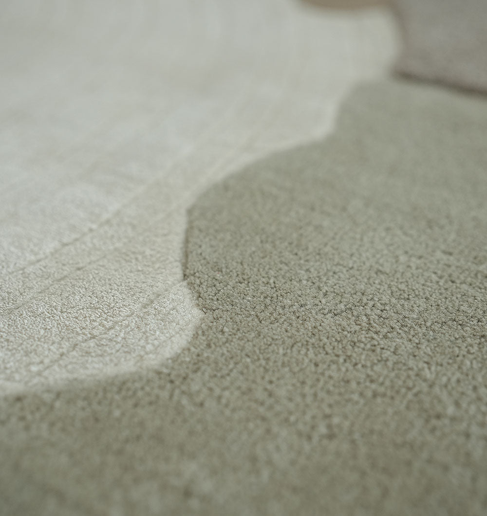 Close-up of the RAMSHA HOME Decorative Handmade Modern Shaped Rug HTWV 185 (183 x 200 cm), showcasing its multicolored, light beige and tan tones, subtle patterns, and soft, plush hand-tufted texture.