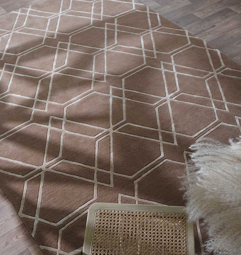 The RAMSHA HOME Stunning Multi Color Hand-Tufted Rug - HTWV 21 (200x300cm) is laid on a wooden floor; a textured chair and a fluffy white throw are visible in the corner.