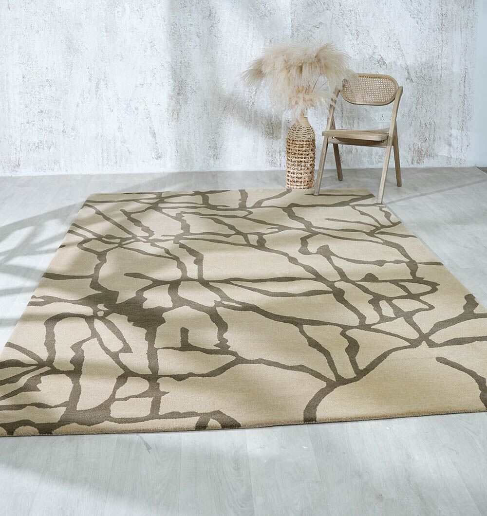 The RAMSHA HOME Stunning Multi Color Fluffy Wool Handmade Rug - HTW 21 (202x292cm) adds cozy style atop a light wood floor, paired with a woven chair and tall vase of pampas grass against a textured white wall.