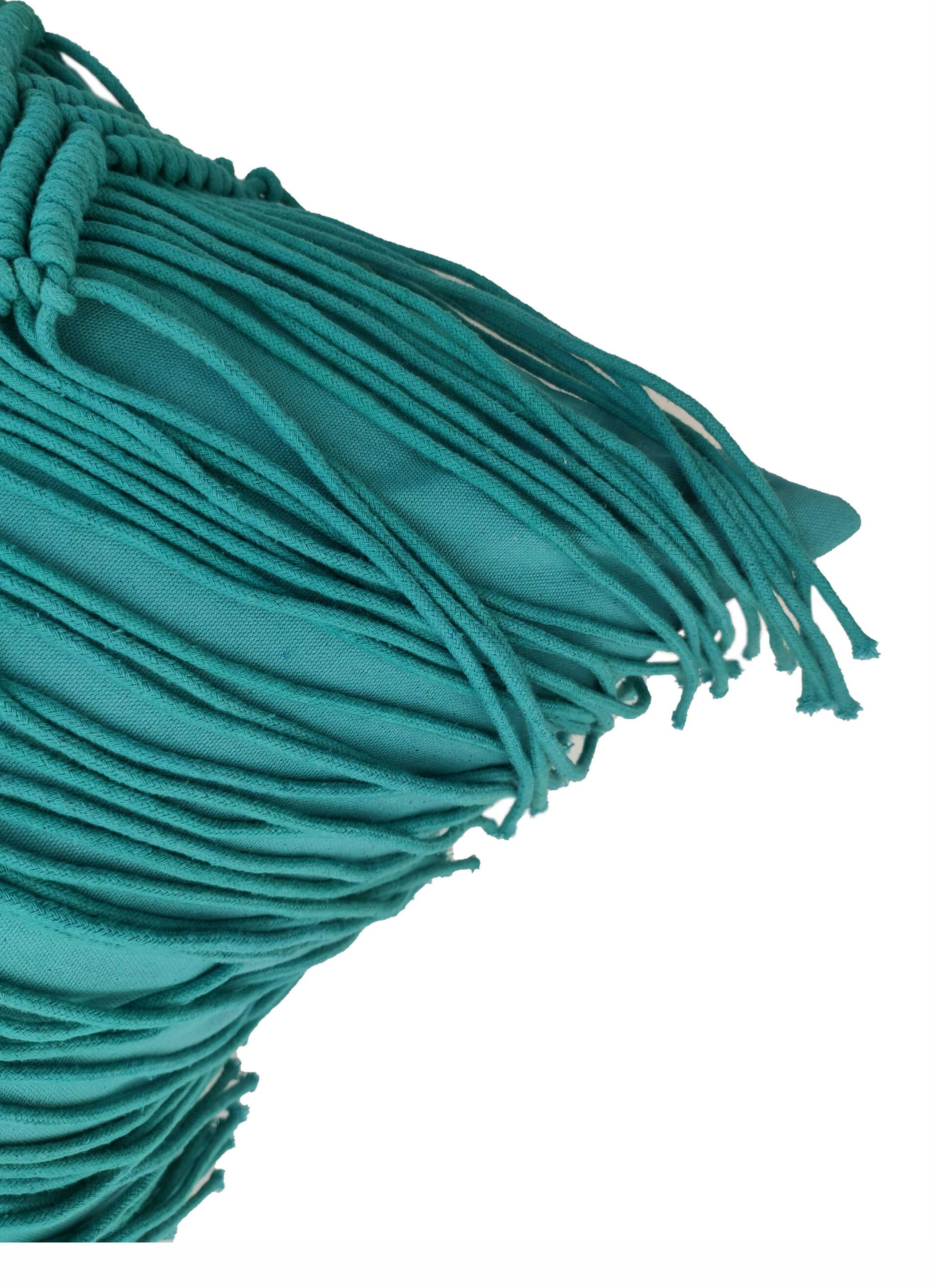 Close-up of teal macrame strands with a gathered fringe, layered loosely against a white background. The soft texture highlights the cozy design of the RAMSHA HOME Macrame Cotton Cushion With Filler.
