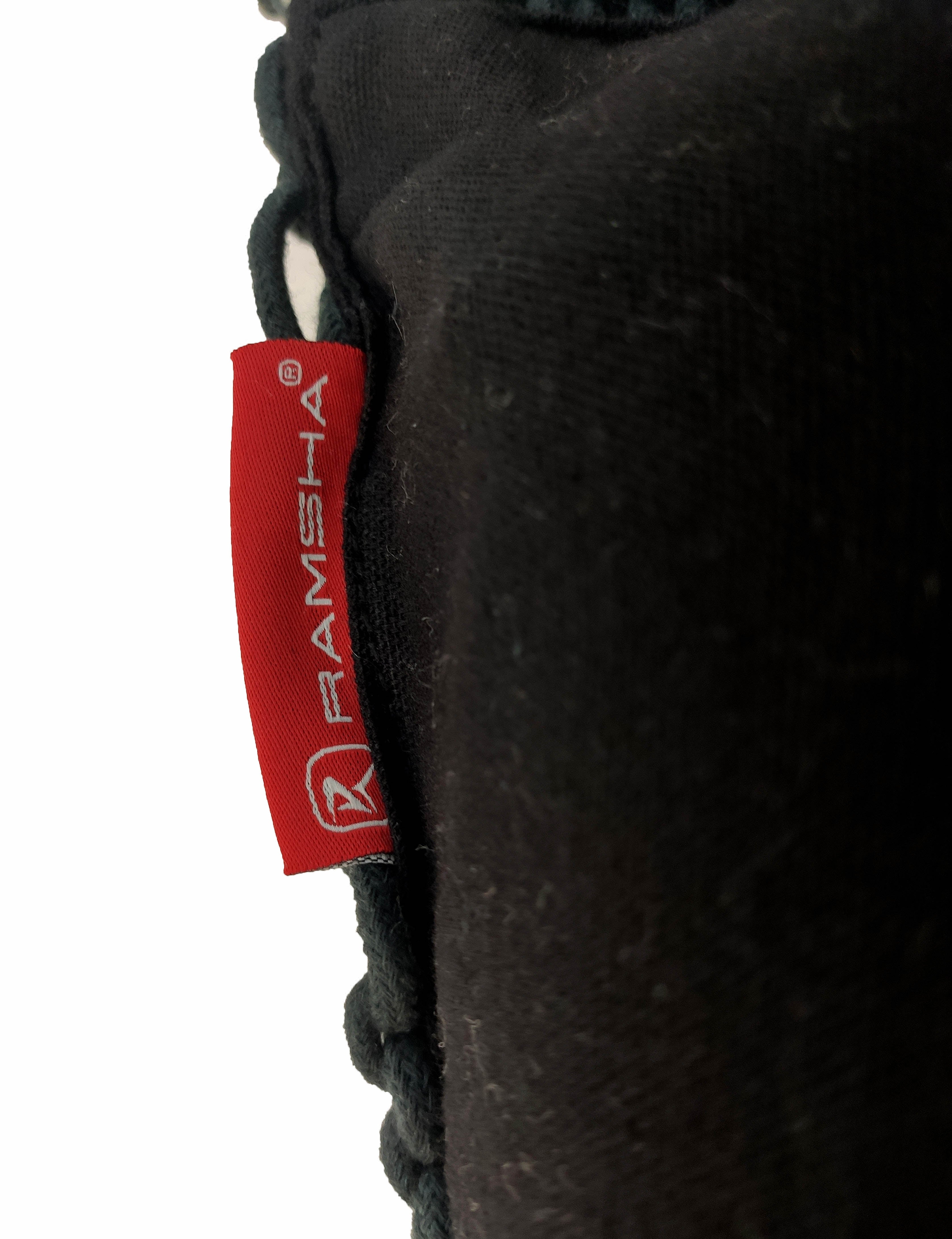 A close-up of the Macrame Cotton Cushion With Filler shows its black fabric, detailed stitching, and texture. A red tag with the RAMSHA HOME logo and white text is clearly visible.