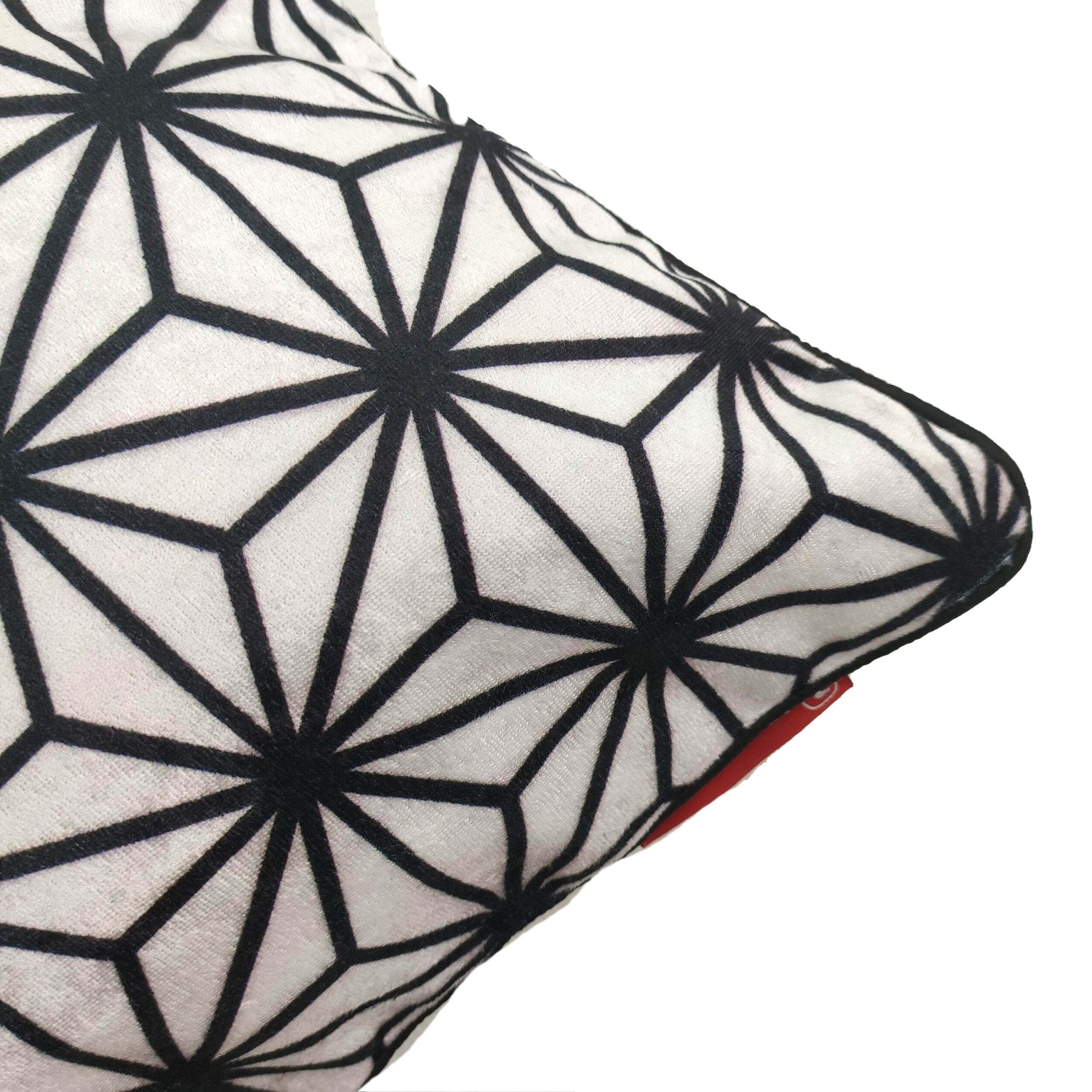 The RAMSHA HOME Polyester Cushion Cover CS-073 features a white base with a black geometric starburst pattern, a small red tag, and textured fabric, adding modern flair to your home decor.