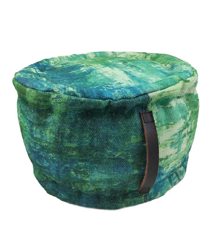 The RAMSHA HOME Printed Multi Color Pouf features a round polyester design with green and blue tie-dye fabric and a brown leather side handle, perfect as a meditation cushion.