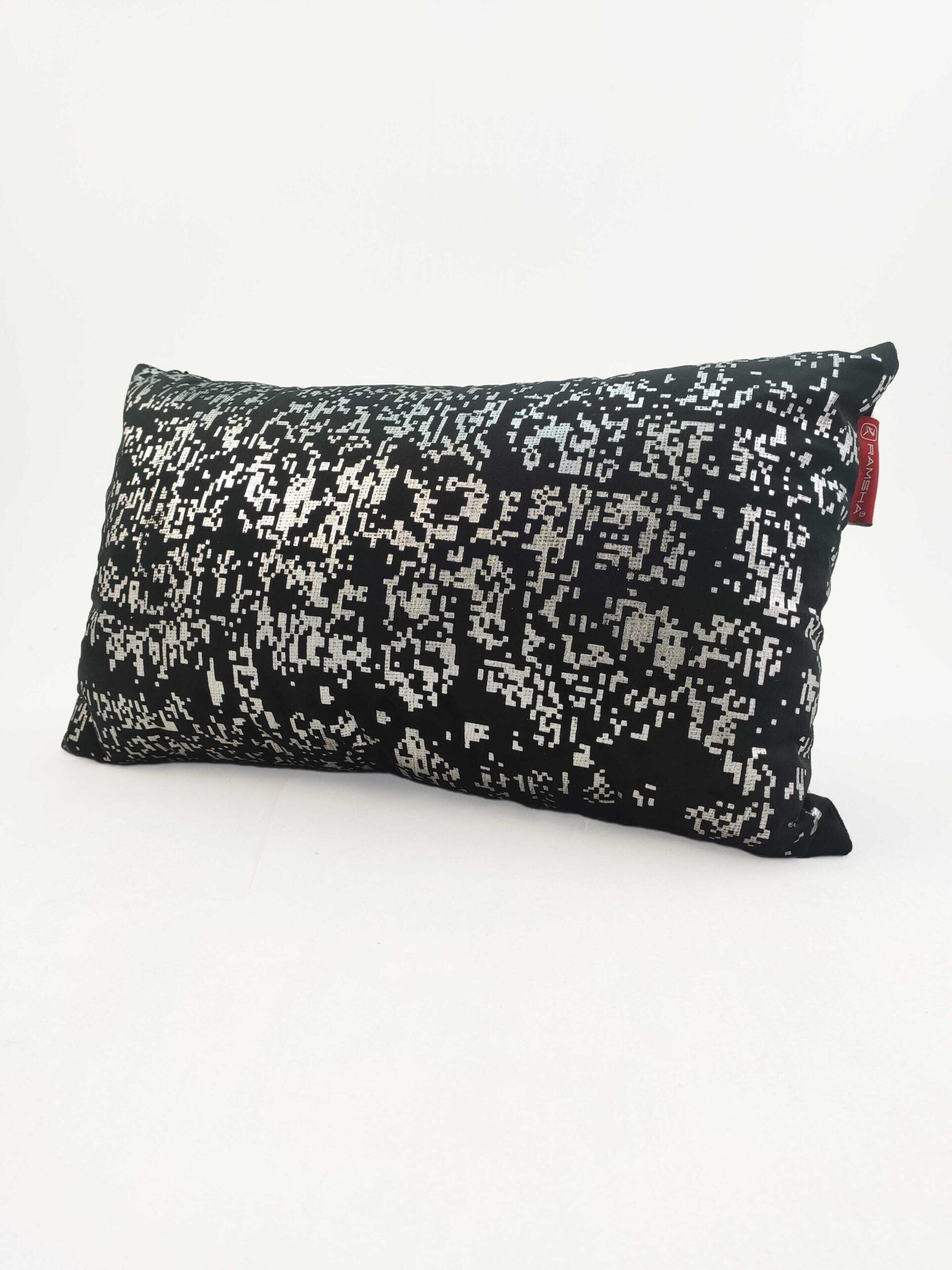 The RAMSHA HOME Decorative Black Color Cushion CS-095 features a silver pixelated design on soft polyester and includes a small red fabric tag, displayed with its filler on a plain white surface.