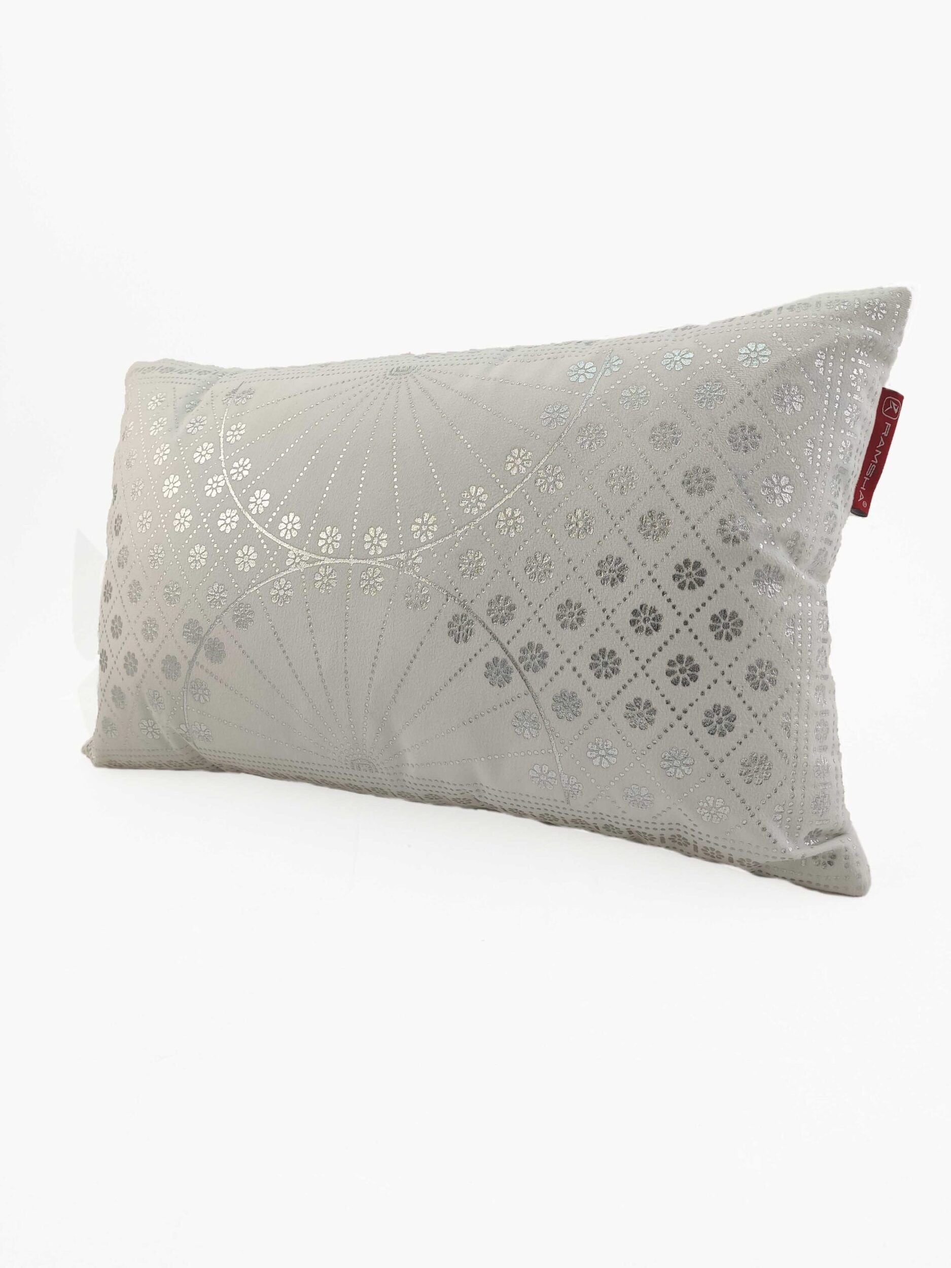 The RAMSHA HOME Decor Polyester Cushion features a light gray geometric and floral pattern in silver, includes filler, and has a small red fabric tag on the side. Stylishly designed for your home decor, shown on a white background.