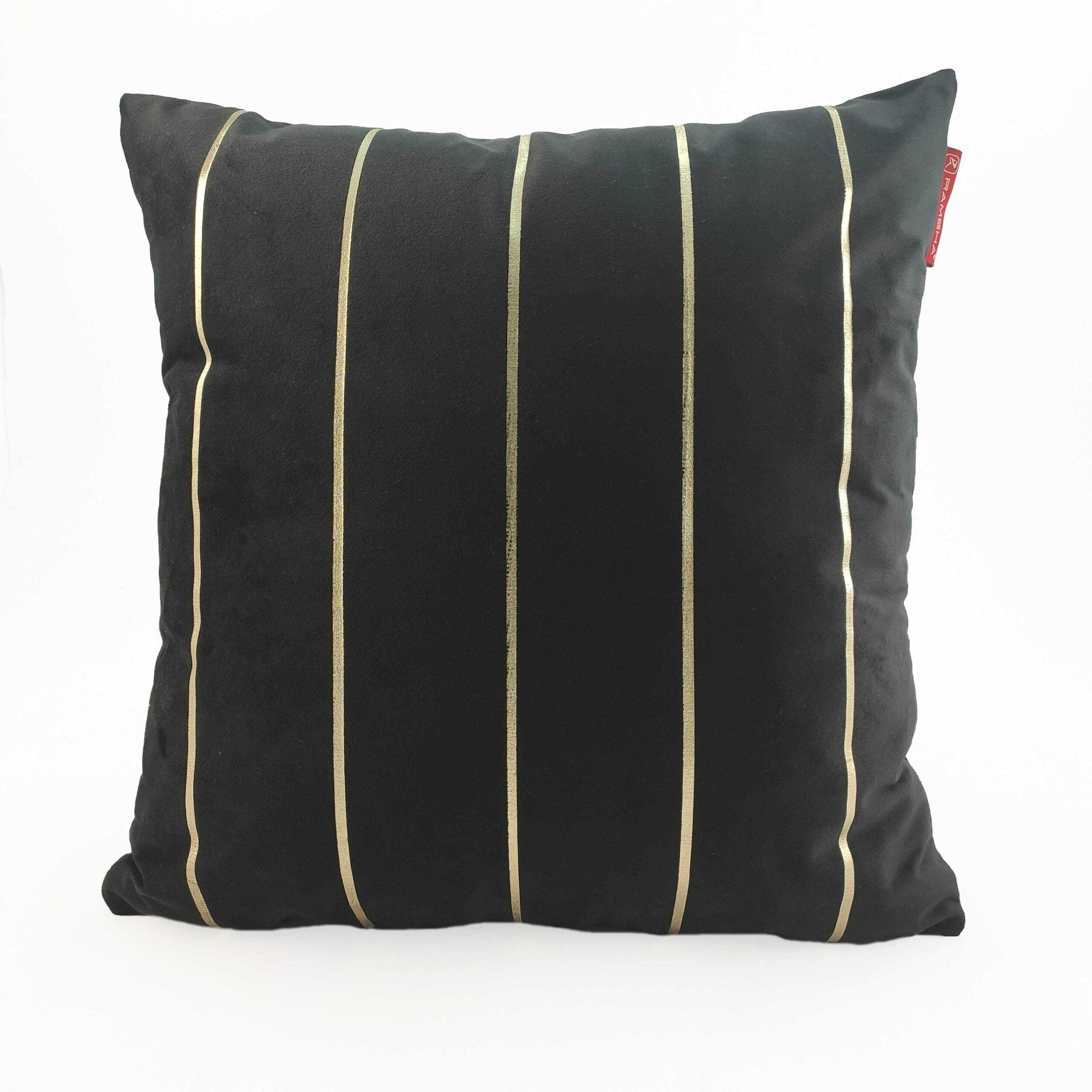 The RAMSHA HOME 100% Polyester Cushion Cover CS-099 is a square black pillow with four vertical gold stripes on the front and a red fabric tag on the upper right. Made from wrinkle-resistant polyester. Shown on a plain white background.