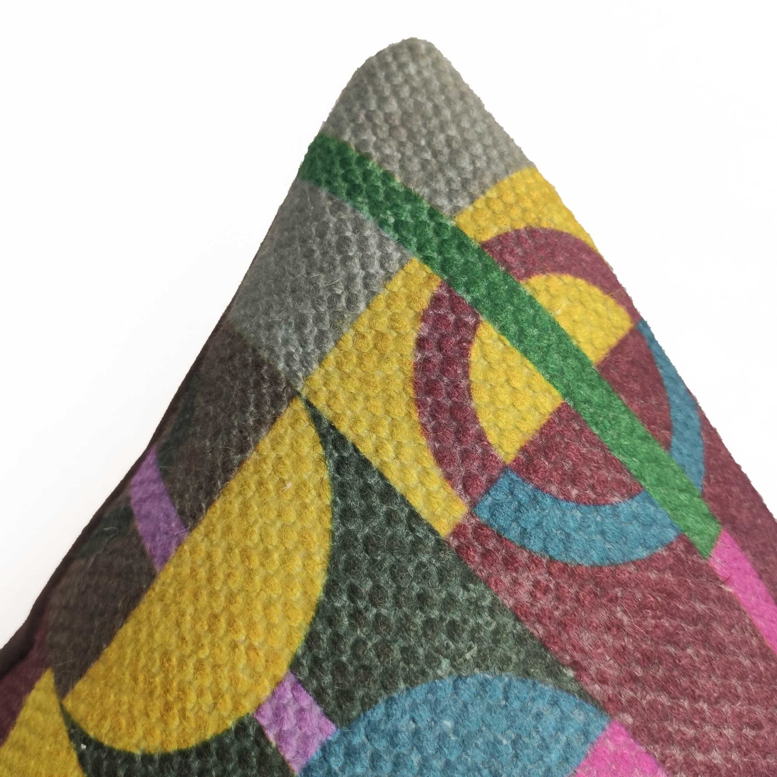 A close-up of the RAMSHA HOME Multi Decor Cushion Cover CS-070 shows geometric circles, semi-circles, and lines in yellow, green, blue, purple, and burgundy on high quality fabric—a vibrant accent for sofas or beds.