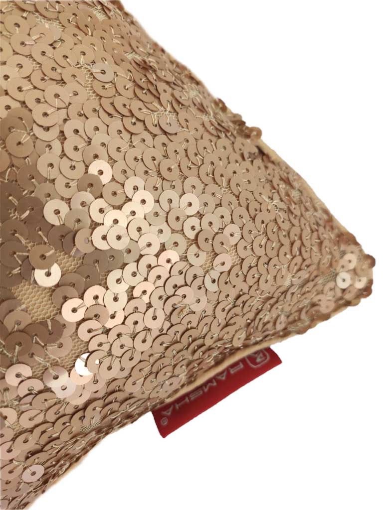 A close-up of the RAMSHA HOME Decor Polyester Cushion With Filler shows its beige sequin cover and red tag, adding a glamorous, plush touch to any home setting.