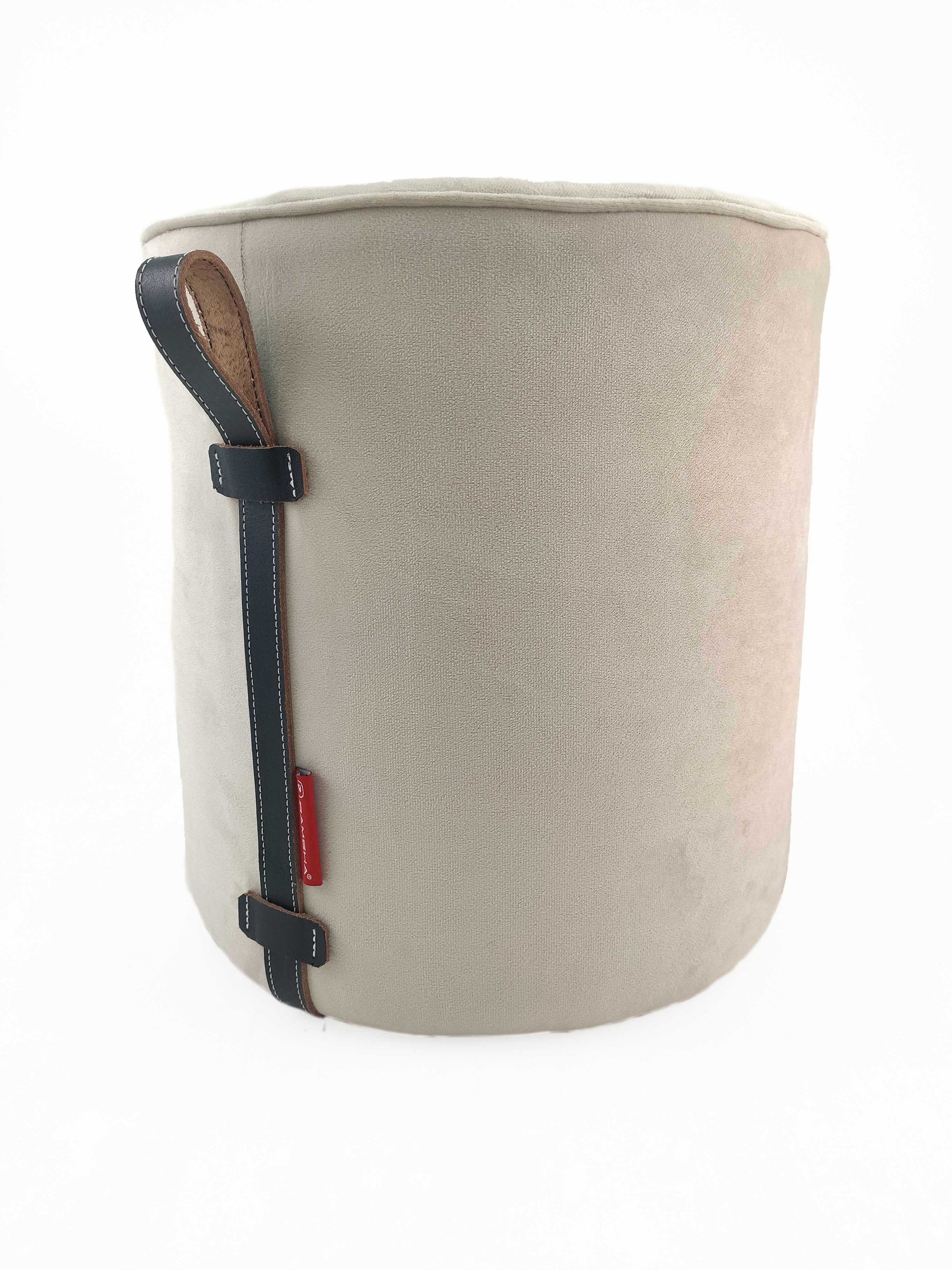The RAMSHA HOME Leather Pedestal Pouf With Leather Handle is a round, light beige pouf with a leather handle on the side, shown against a plain white background.