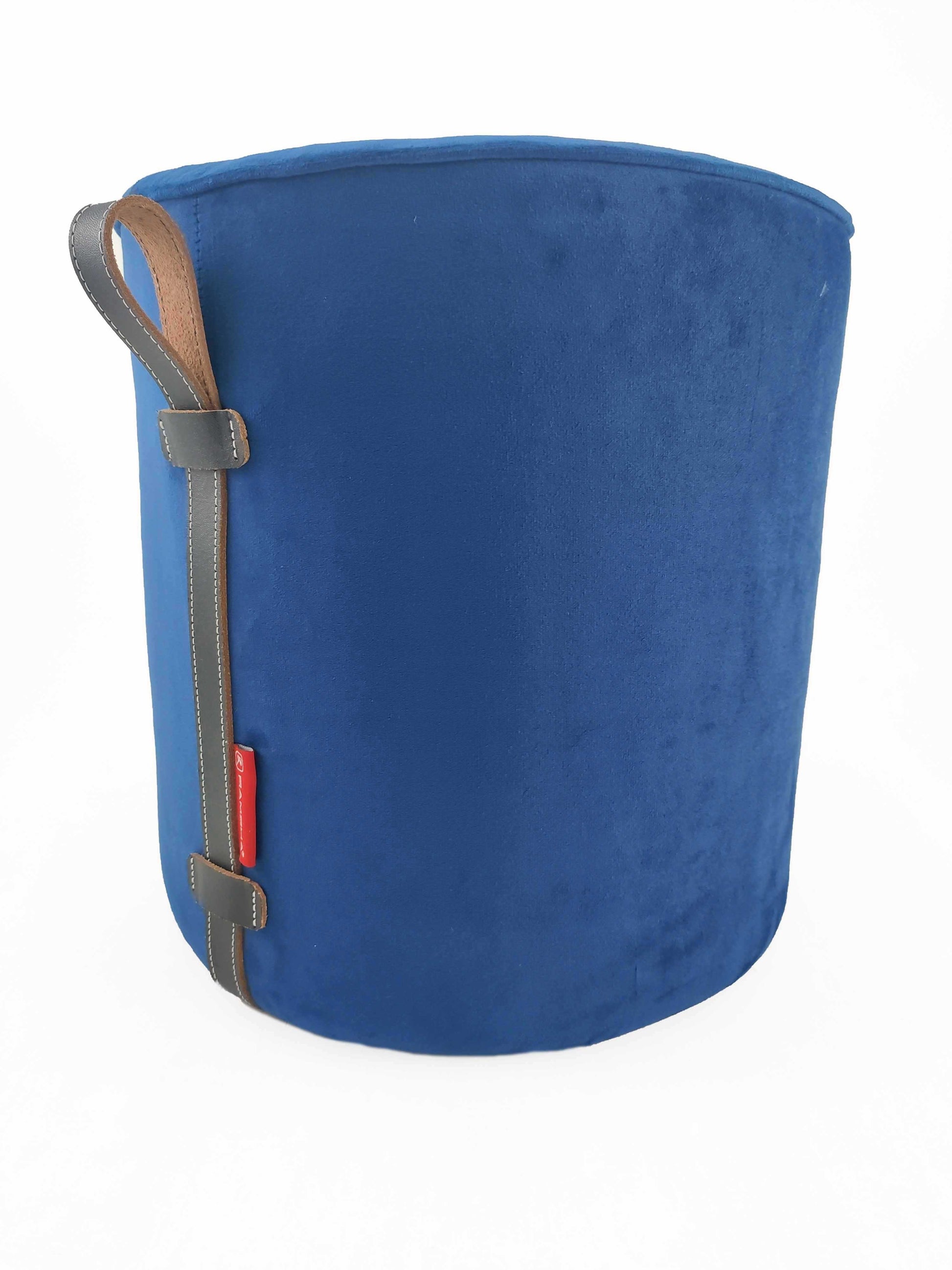 The RAMSHA HOME Leather Pedestal Pouf features a plush blue cylindrical design with a brown and gray faux leather handle, accented by a small red tag. The background is white.