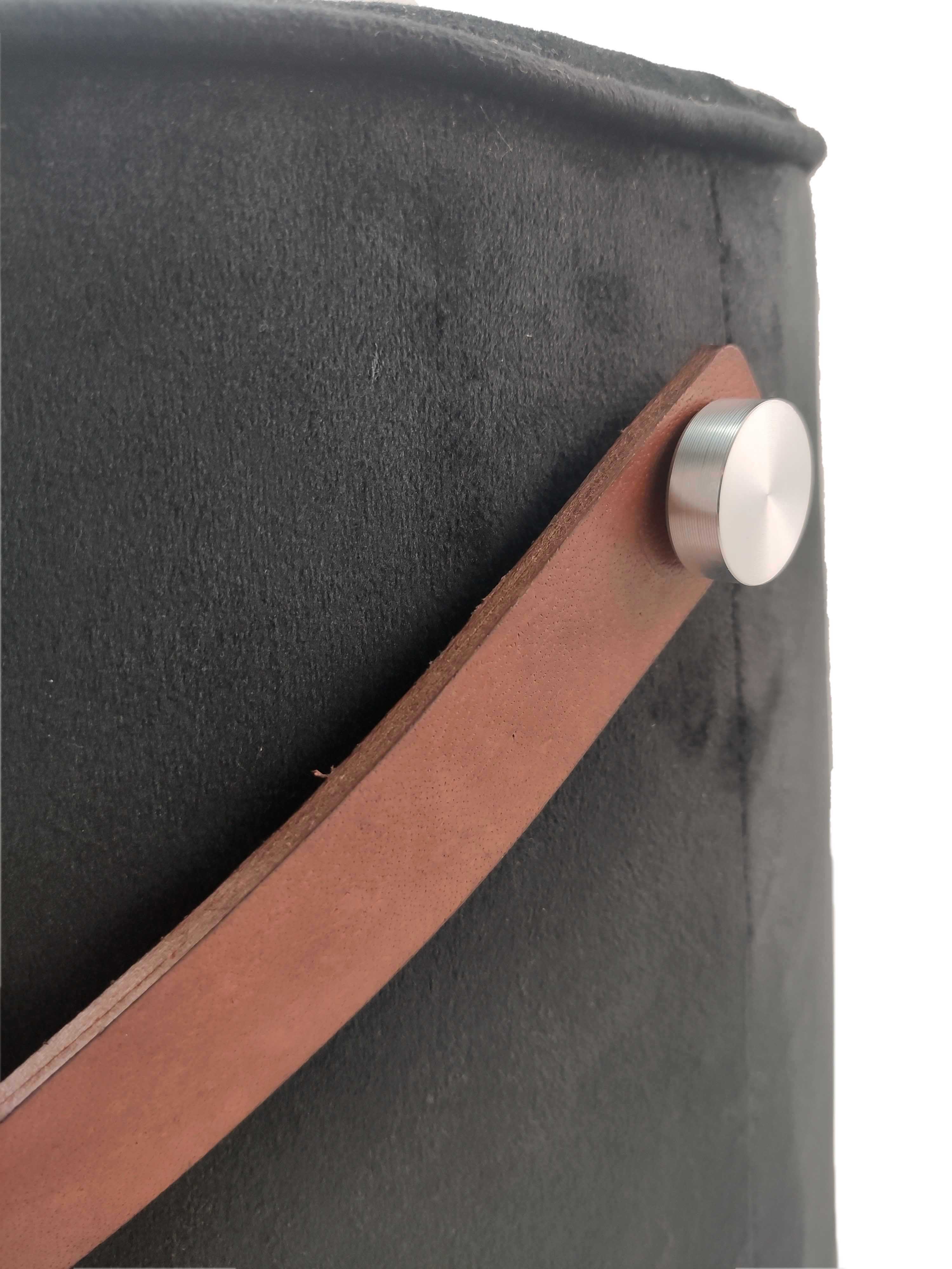 Close-up of the brown leather handle on the RAMSHA HOME Leather Pedestal Pouf With Leather Handle, attached with a round metallic button to the black fabric. Highlights texture and details—ideal for adding functional style to your decor.