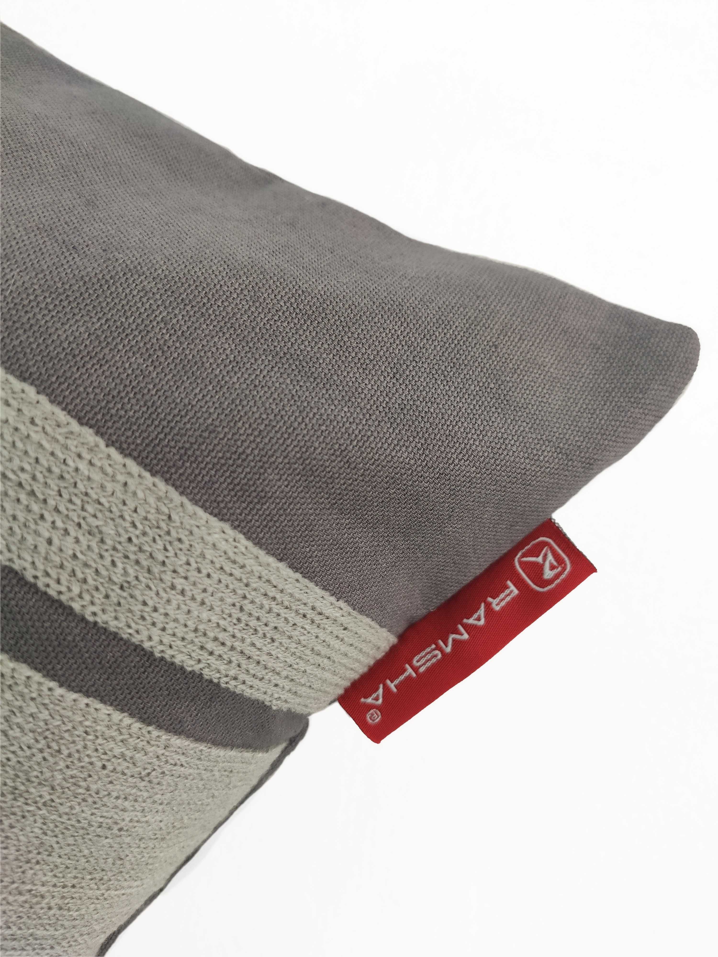 A close-up of the Grey Color Cushion CS-119 by RAMSHA HOME, made from a soft cotton-polyester blend with off-white stripes and a red tag bearing the RAMSHA logo. The background is plain white.