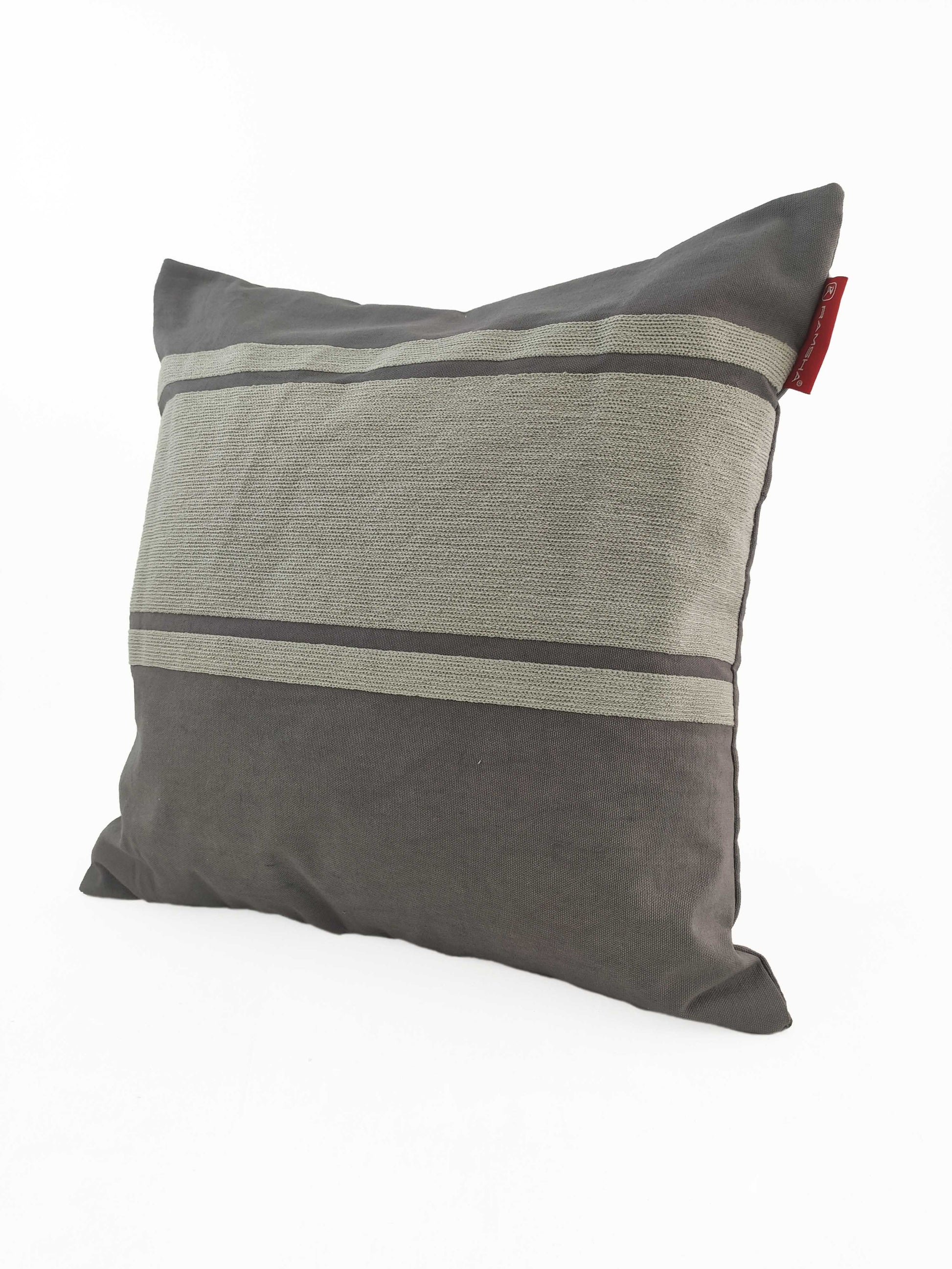 The RAMSHA HOME Grey Color Cushion CS-119 is a square cushion in a cotton-polyester blend, with dark grey fabric, lighter grey horizontal stripes, and a small red tag on the right edge, displayed against a white background.
