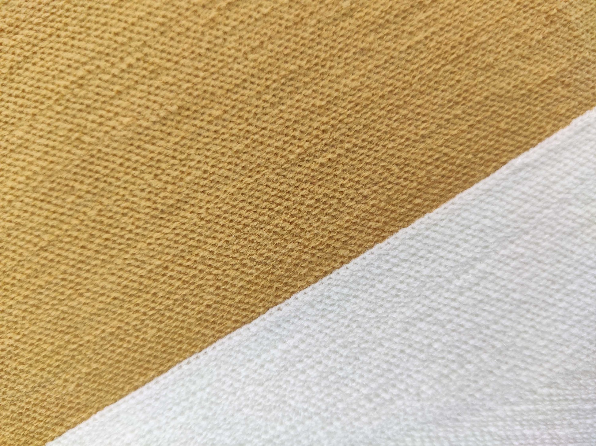 Close-up of RAMSHA HOME’s Home Decor Cushion CS-120 shows light brown and white textured fabrics intersecting diagonally, both featuring a durable woven pattern that highlights their quality construction.