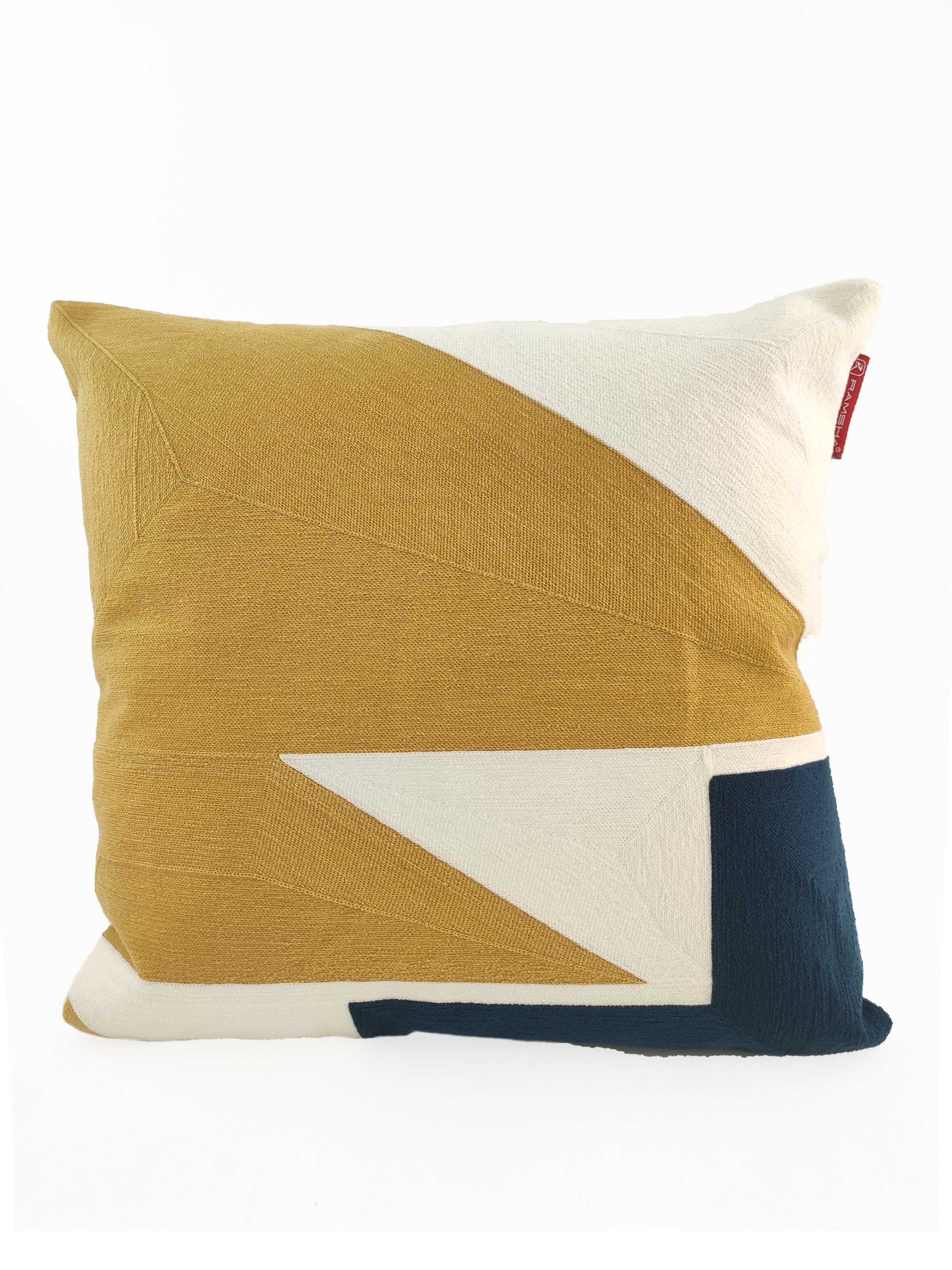 The RAMSHA HOME Home Decor Cushion CS-120 is a square cotton-polyester cushion featuring a geometric design in mustard yellow, white, and dark blue on a plain white background.