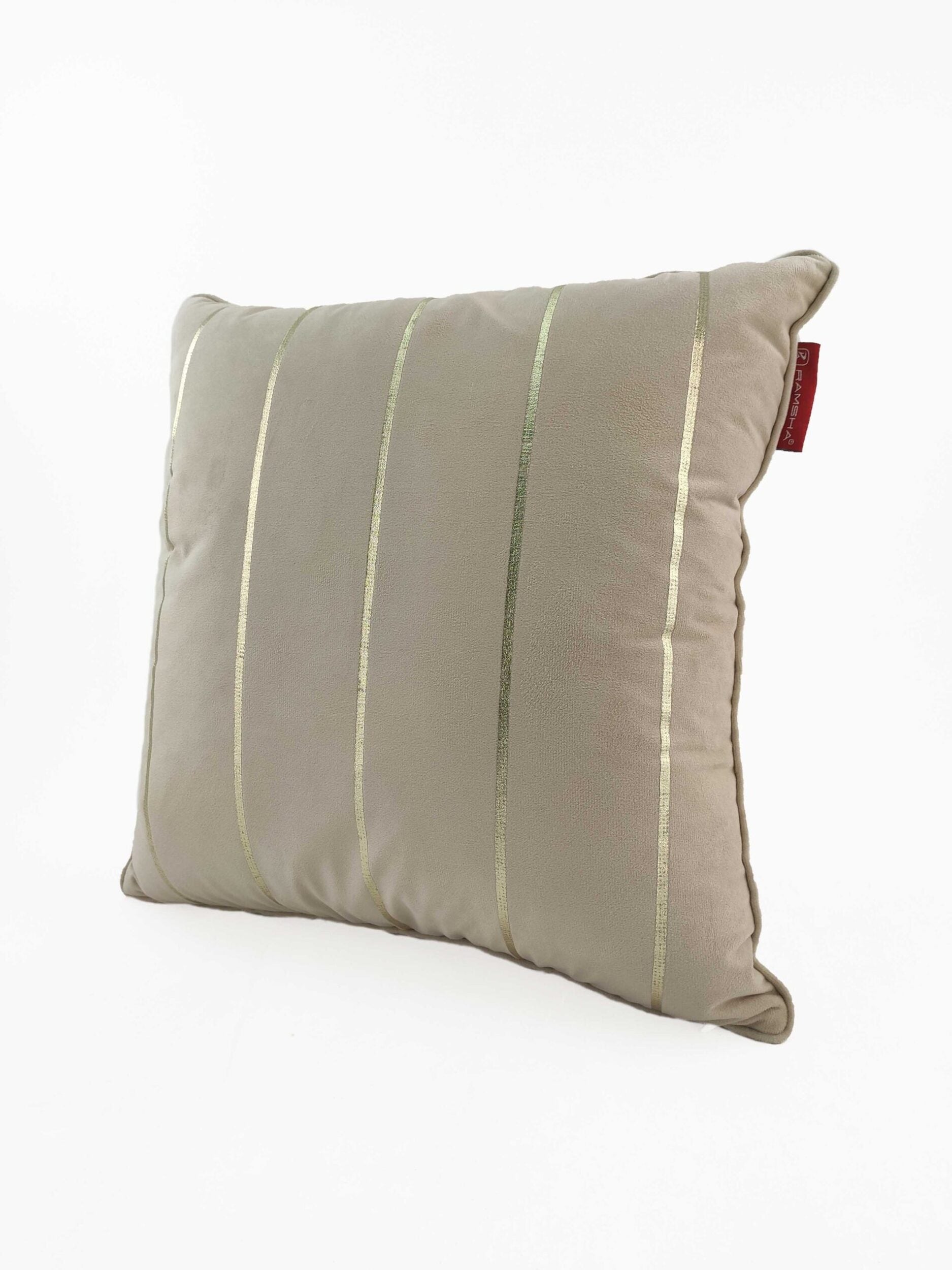 The RAMSHA HOME 100% Polyester Cushion Cover CS-099 is a beige throw pillow with vertical metallic gold stripes and a small red fabric tag on the side, shown against a plain white background.