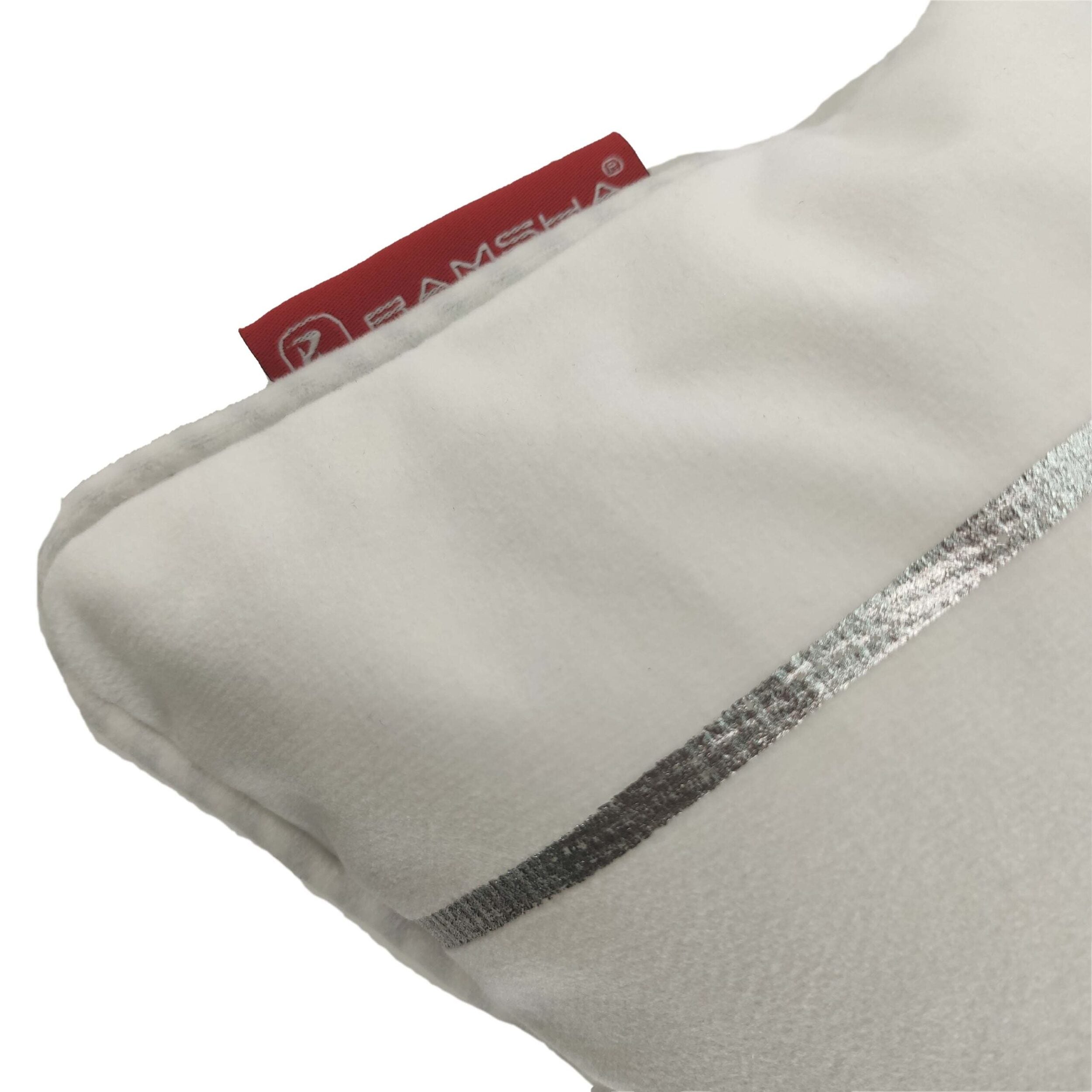 Close-up of a wrinkle-resistant white pillow with a silver stripe and visible red fabric tag, featuring the RAMSHA HOME 100% Polyester Cushion Cover CS-099.