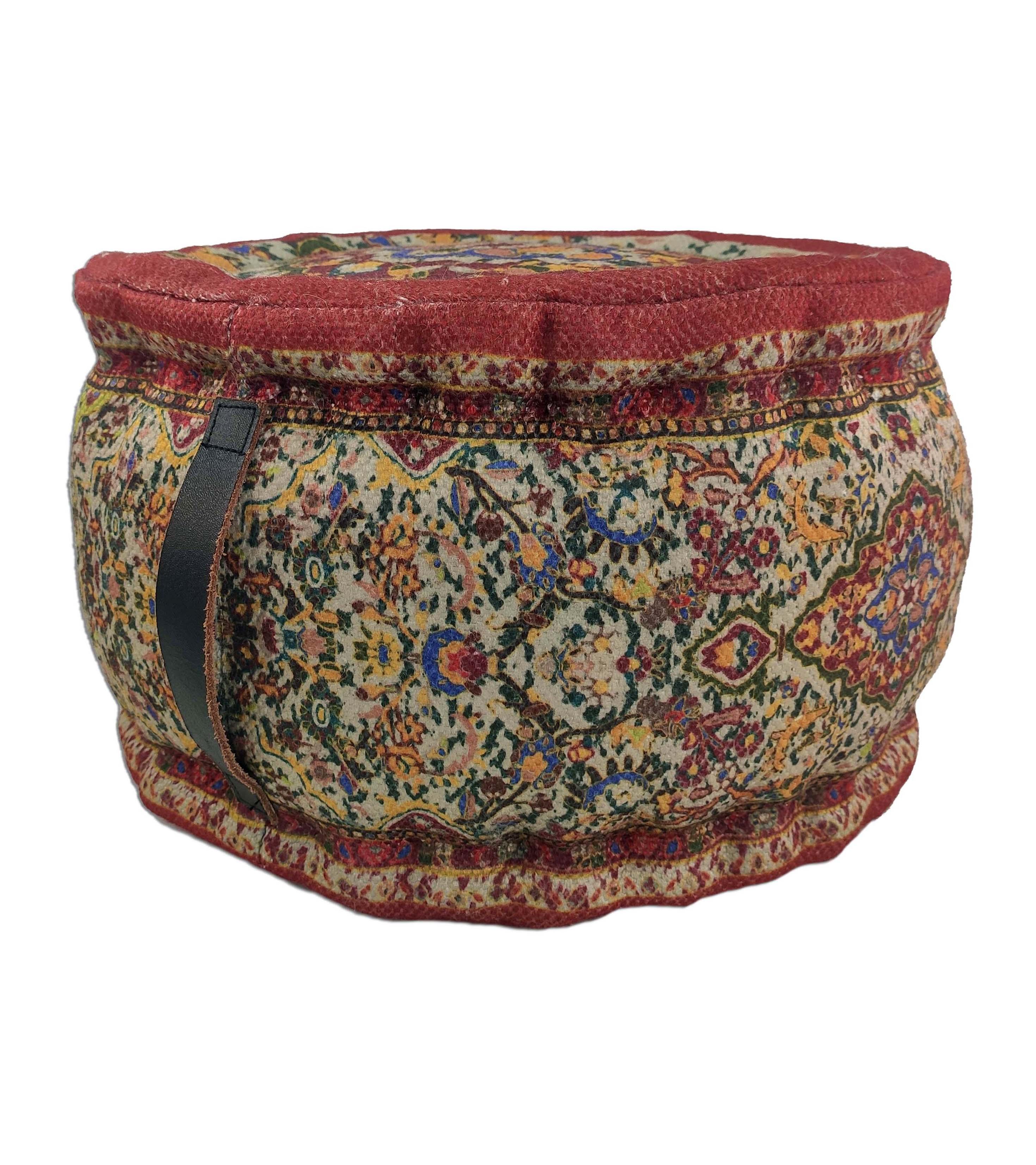 The RAMSHA HOME Printed Pedestal Multi Color Pouf With Leather Handle PF-029 features a vibrant floral and geometric pattern in red, gold, green, and cream with a black leather side handle—an eye-catching accent for your home.