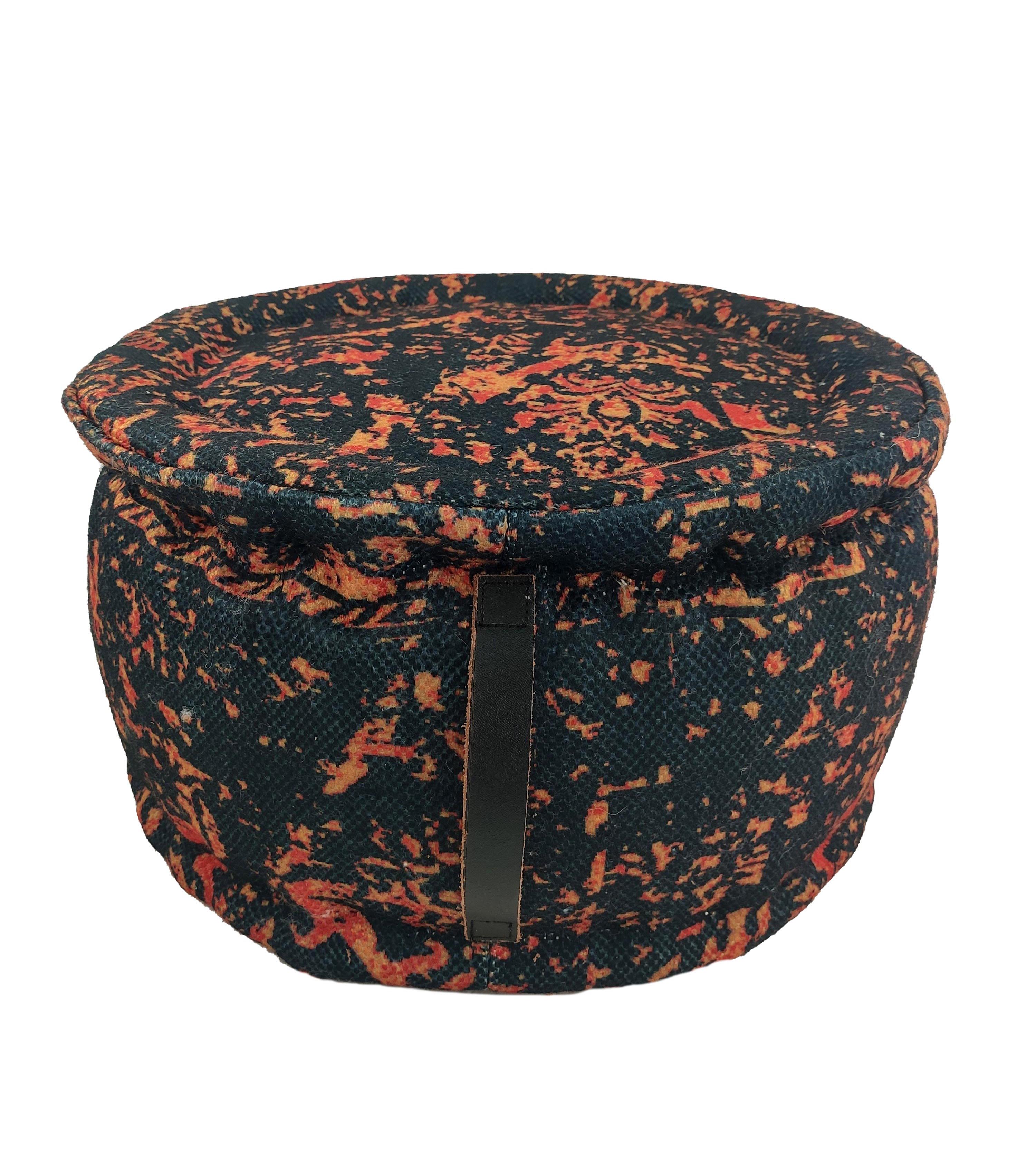 The RAMSHA HOME Printed Multi Color Pouf With Leather Handle features a vibrant speckled design, black background, secure lid, and a stylish leather handle on the front for convenient access.