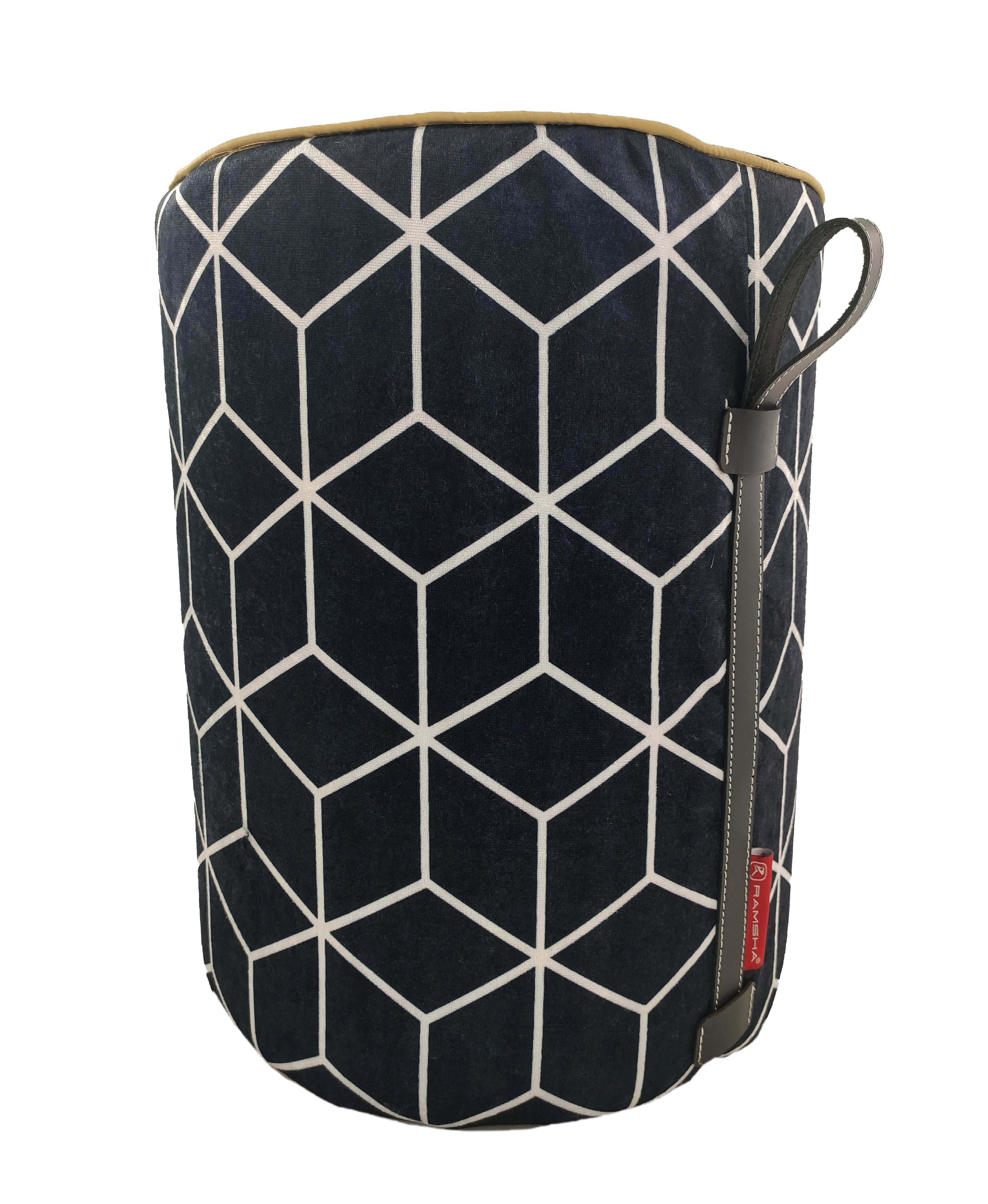 The RAMSHA HOME Printed Pedestal Pouf With Leather Handle PF-028 features dark blue fabric with a white cube pattern, brown trim, a red tag, and a leather handle—an ideal accent piece for stylish home decor.