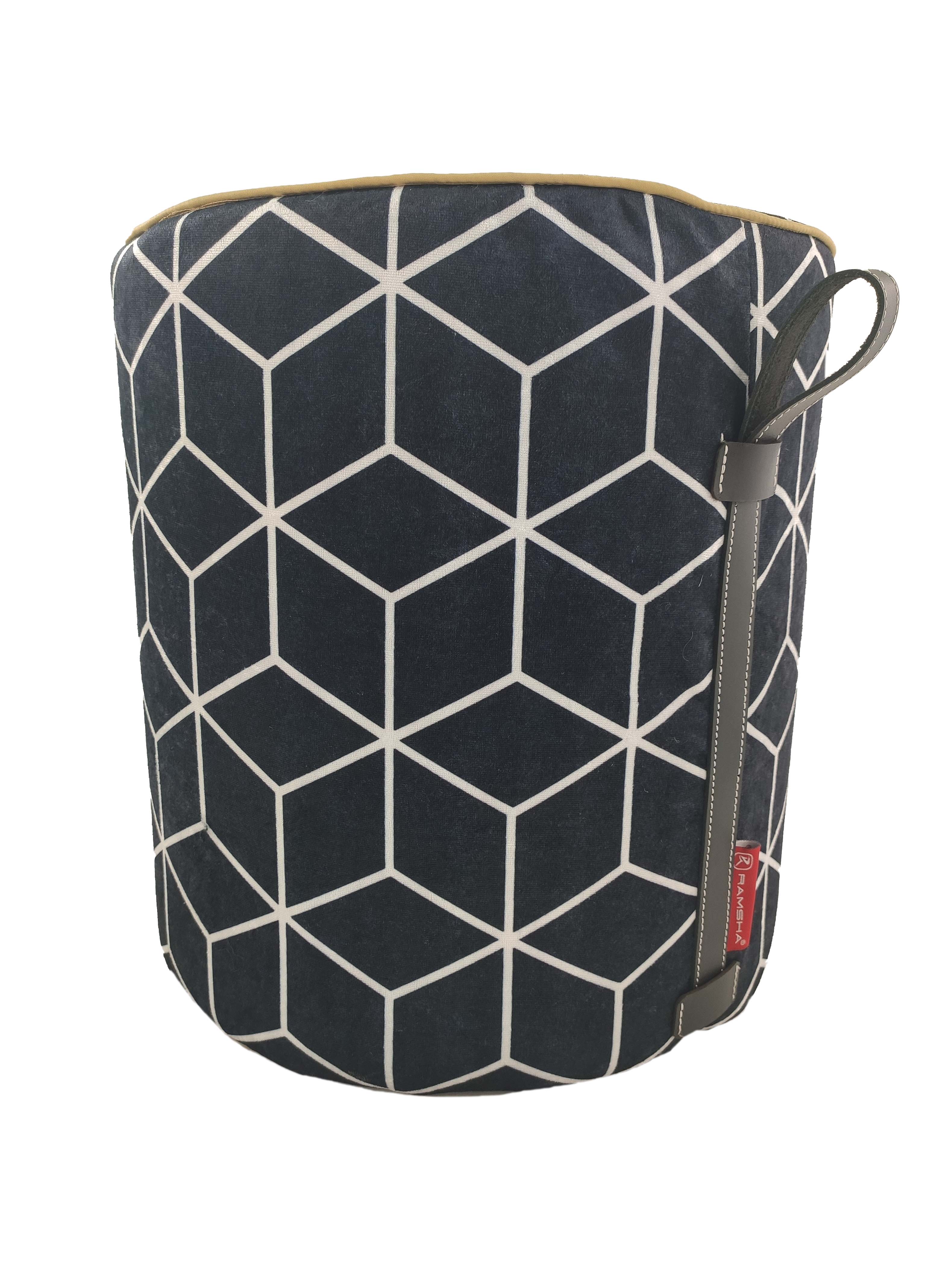 The RAMSHA HOME Printed Pedestal Pouf With Leather Handle PF-028 features a geometric white cube design on a dark background, brown leather handle, and red tag—ideal for adding stylish decor to your home.