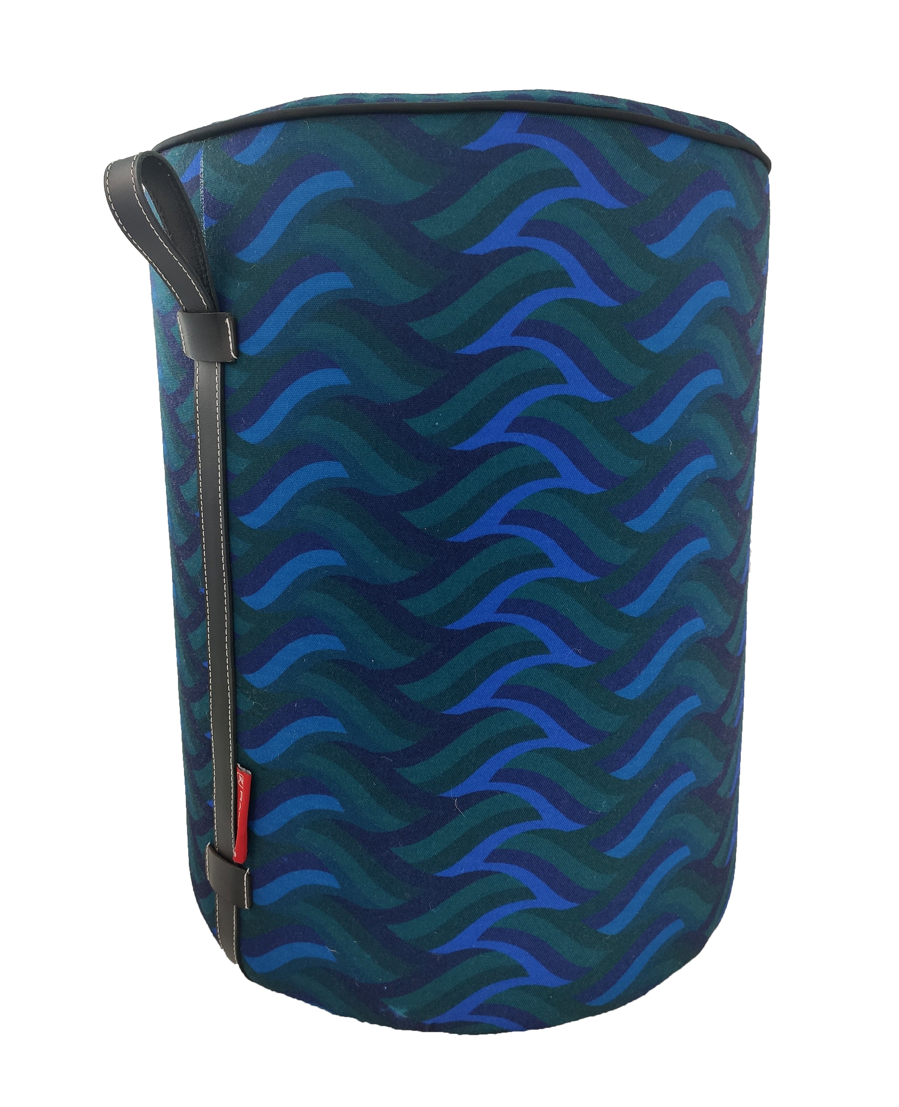 The RAMSHA HOME Blue Printed Pedestal Pouf With Leather Handle PF-037 features a blue and green wavy pattern, black leather handle, and red side tag—a stylish accent for your home decor.