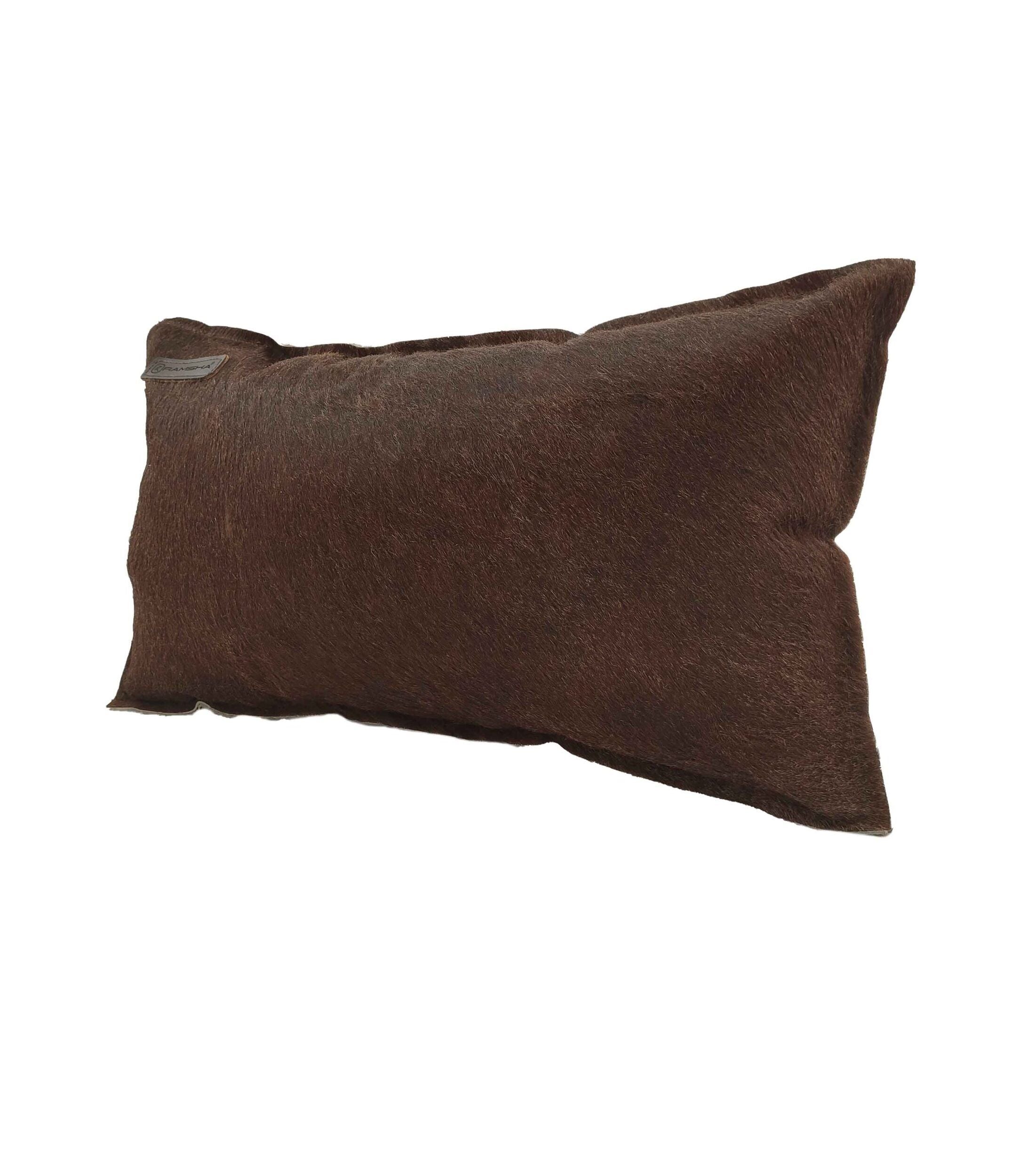 The RAMSHA HOME Leather Cushion With Filler CS-091 is a rectangular, brown cushion with a slightly textured leather surface, set against a white background. It looks soft and plush.