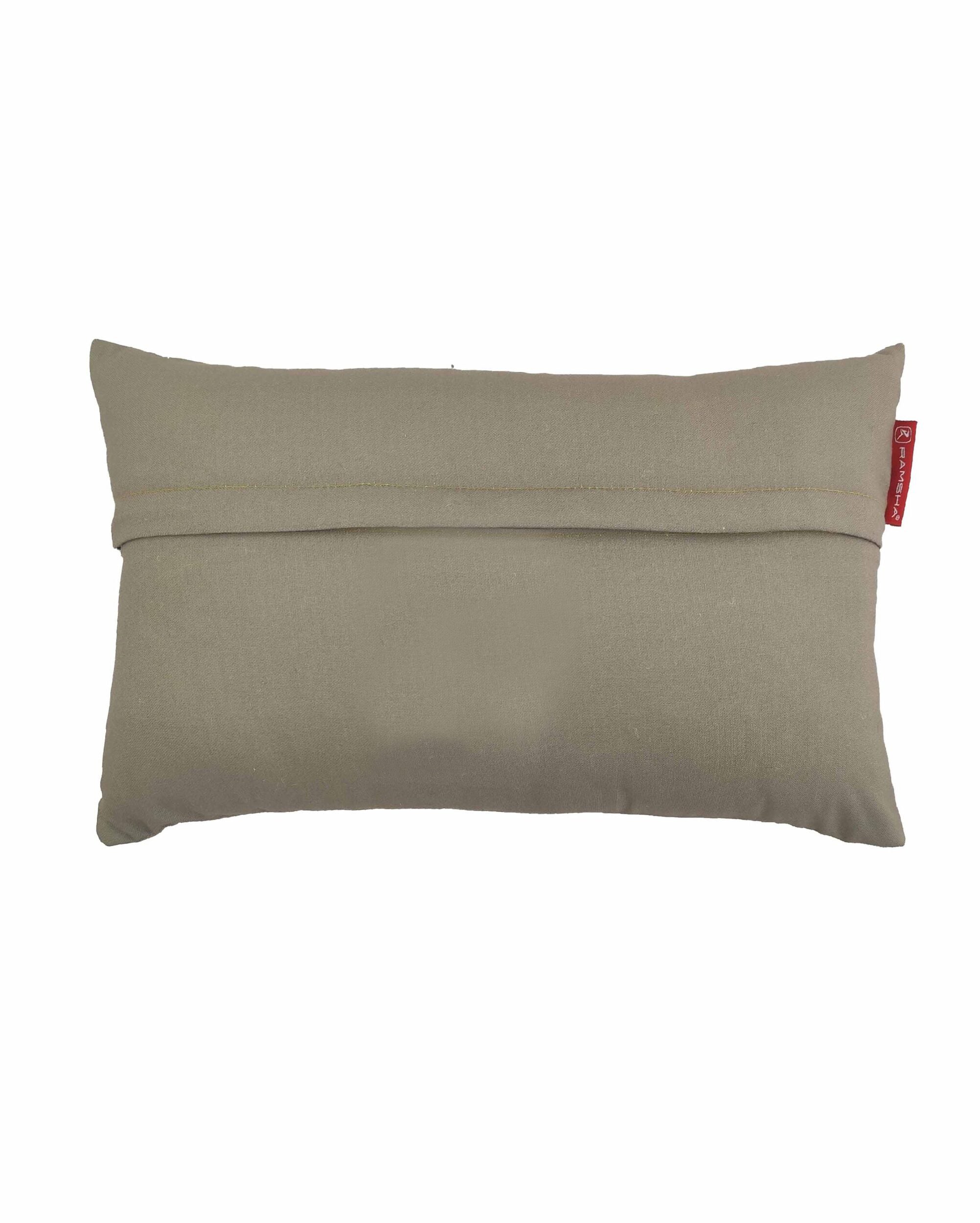 The RAMSHA HOME Polyester & Leather Cushion CS-101 is a rectangular beige pillow with a stitched flap closure and a small red tag, ideal for adding comfort to your living space. Pillow is displayed against a white background.