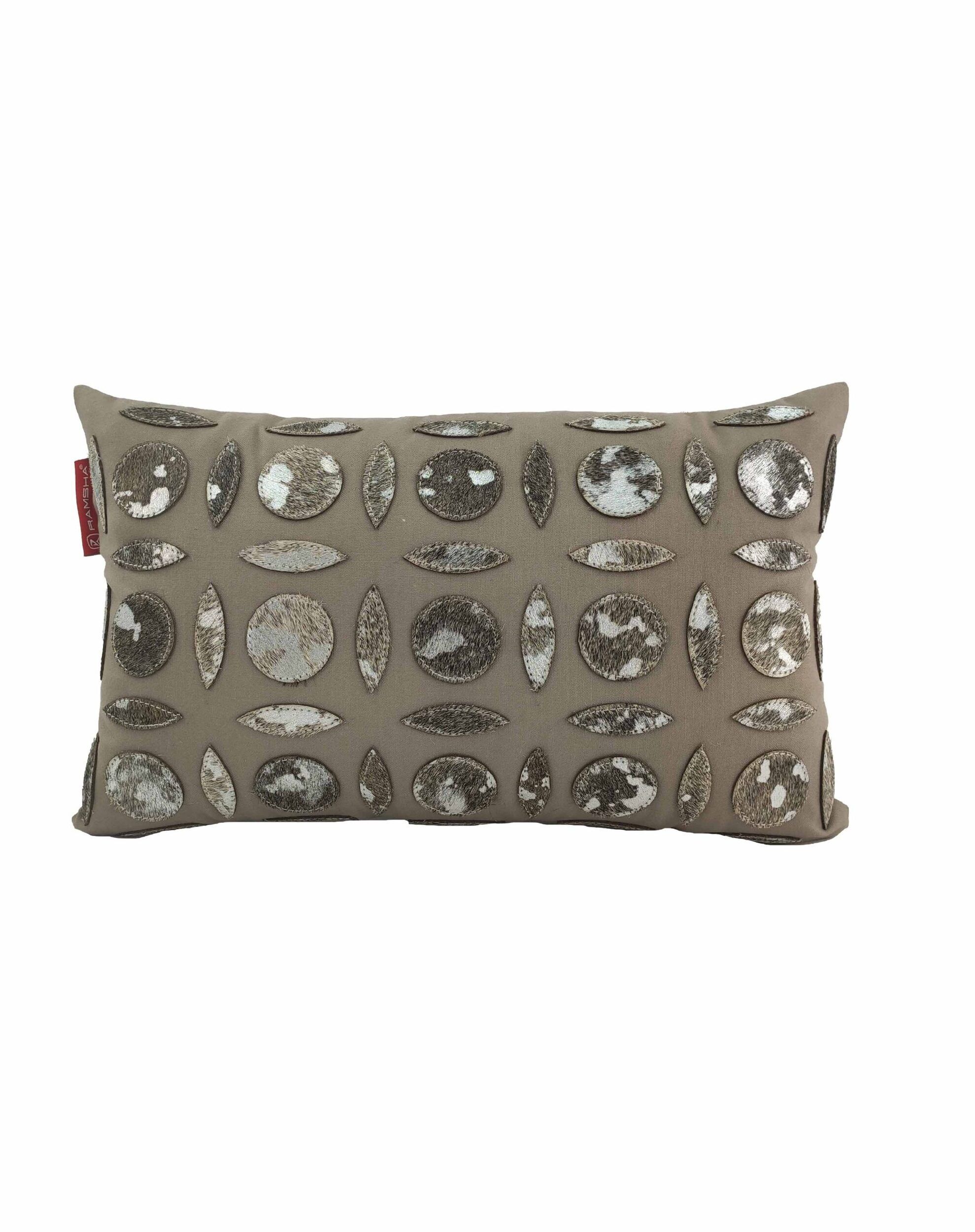The RAMSHA HOME Polyester & Leather Cushion CS-101 is a rectangular beige cushion adorned with rows of round and oval metallic sequins, featuring a premium filler for added comfort and style to enhance your living space.
