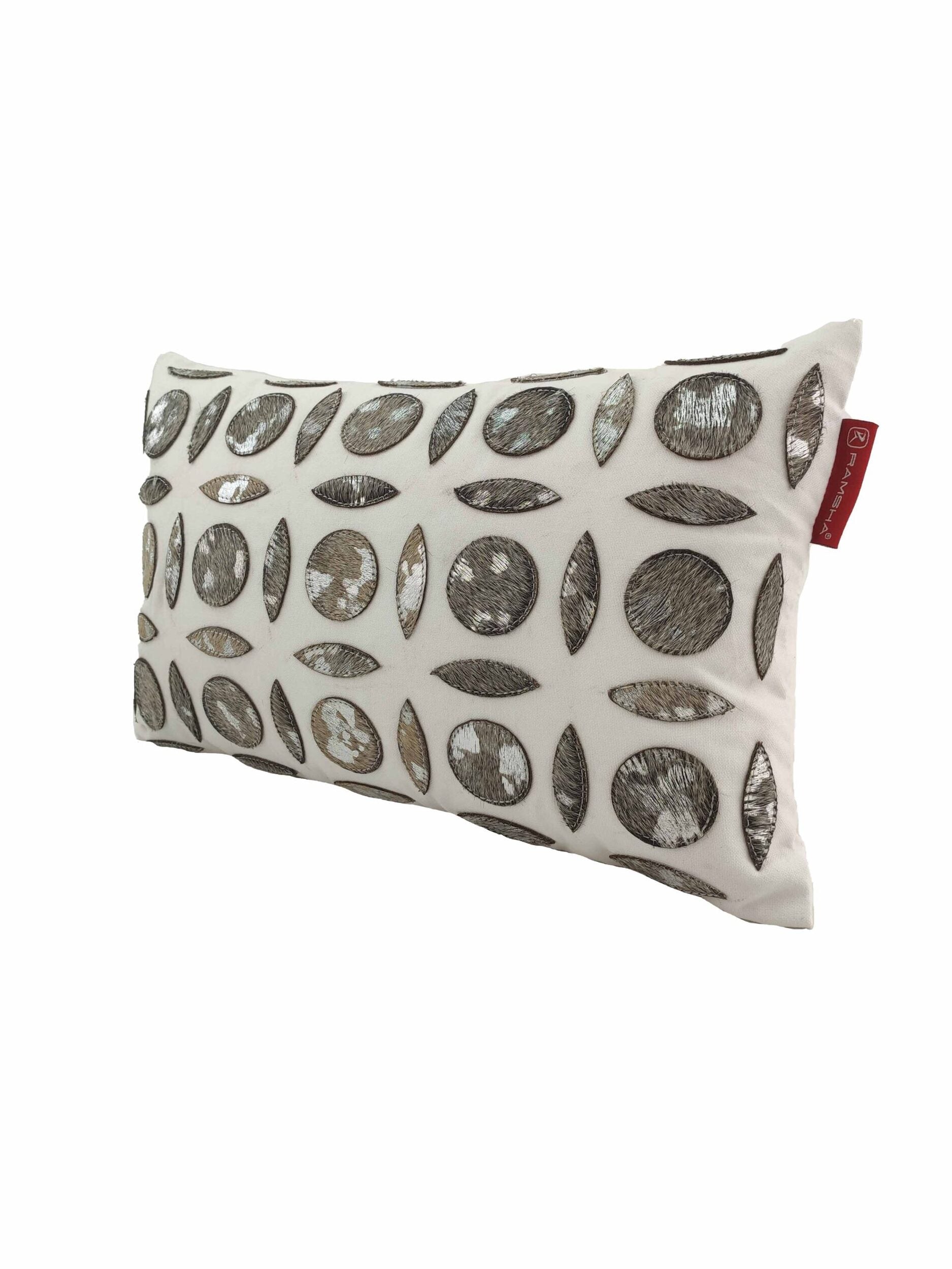 The RAMSHA HOME Polyester & Leather Cushion CS-101 features metallic silver and bronze embroidered circles and ovals on white, a red fabric tag, and includes a plush premium filler for modern style and comfort.