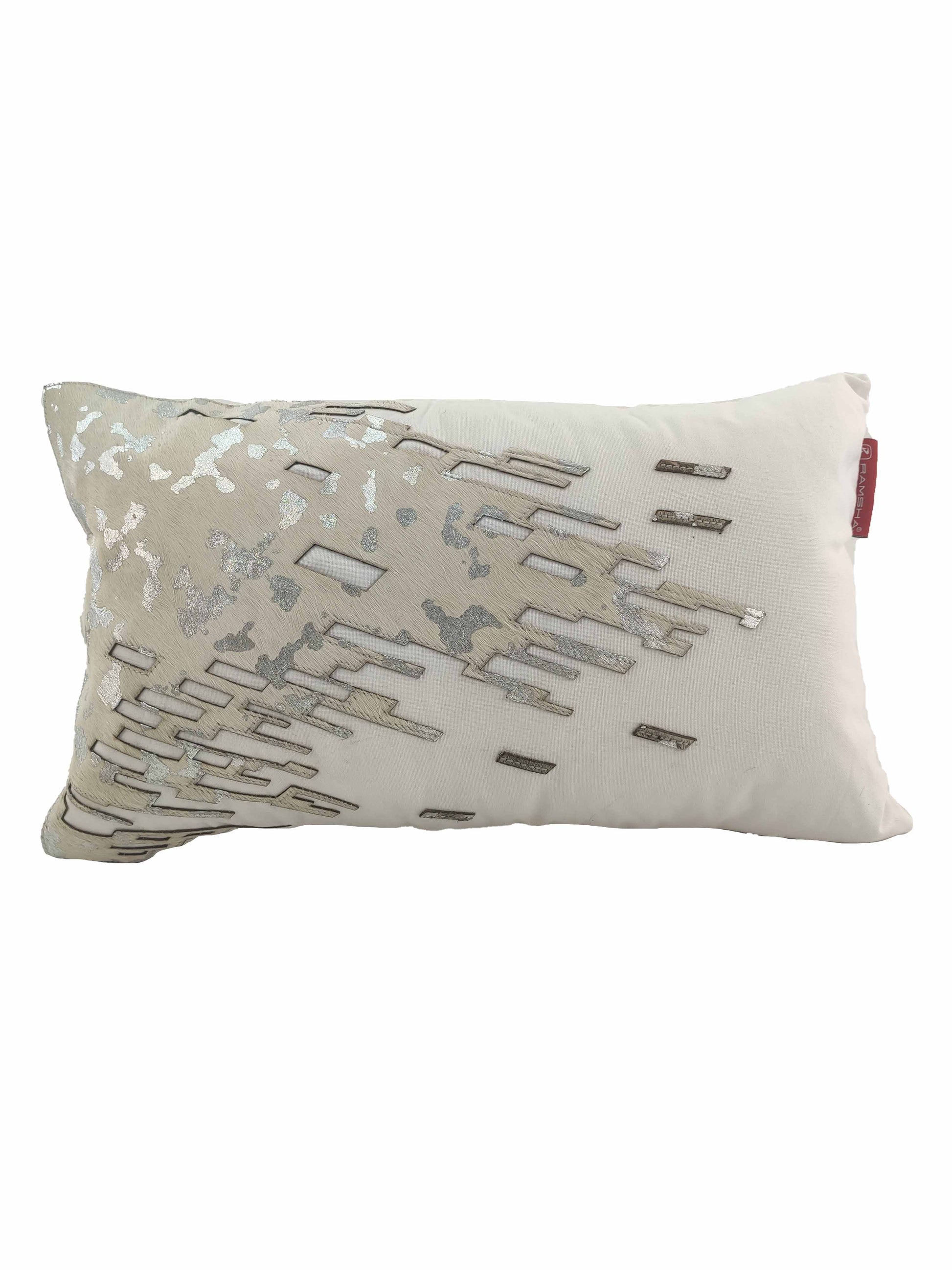 The RAMSHA HOME CS-108 Leather Decor Cushion is a rectangular white cushion with a geometric silver and beige embroidered pattern on one side and a small red fabric tag on the edge.