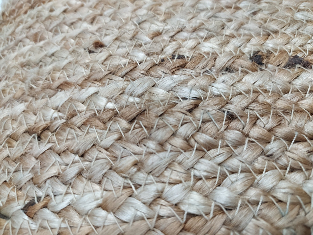 Close-up of the Natural Jute Cushion CS-134 by RAMSHA HOME, featuring woven beige and light brown jute strands in a braided pattern that highlights the cushion’s texture and color variations.