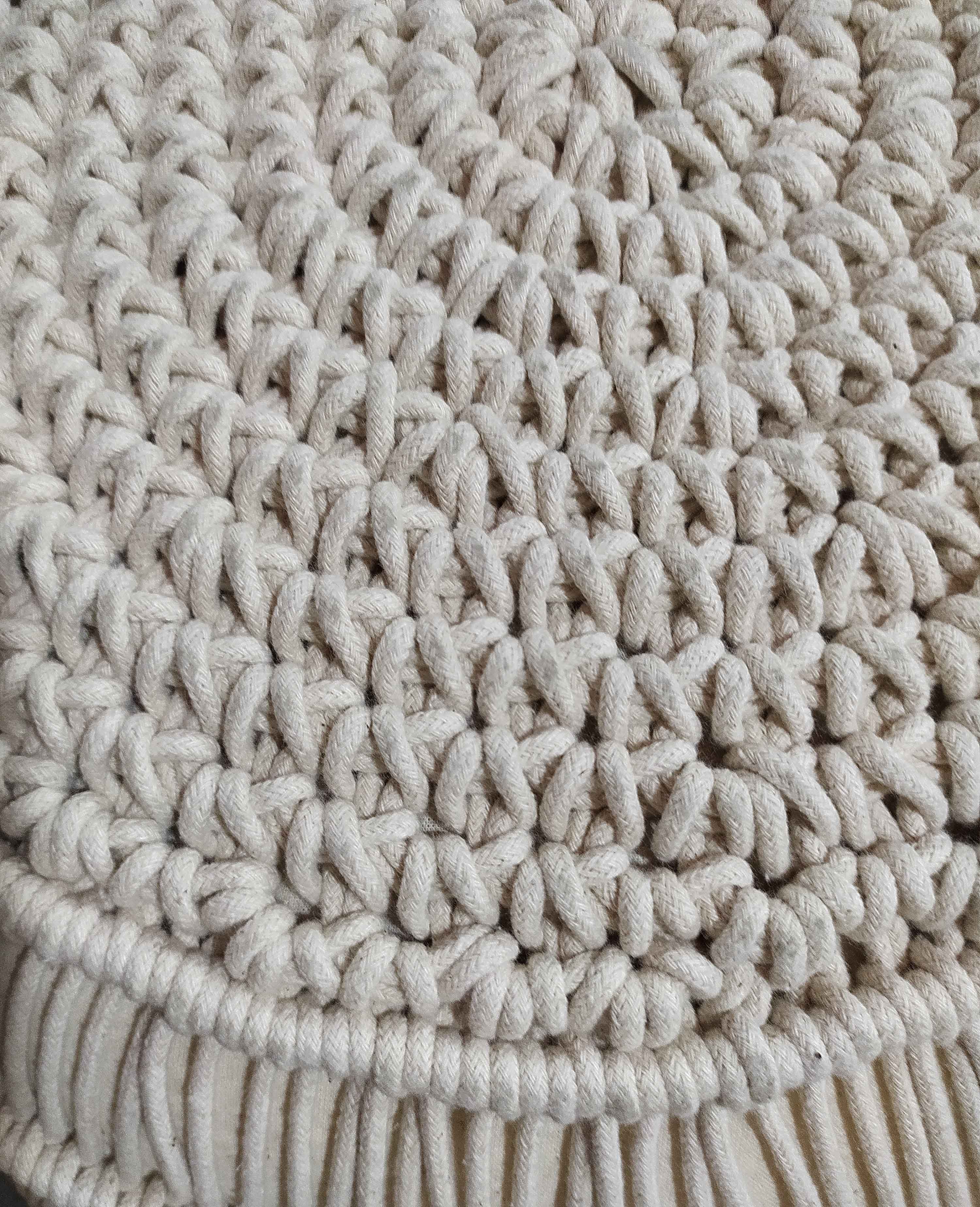 Close-up of the RAMSHA HOME Macrame Cotton Pouf, featuring a round, cream-colored surface with thick, intertwined rope fibers—ideal for adding boho-style charm to your space.
