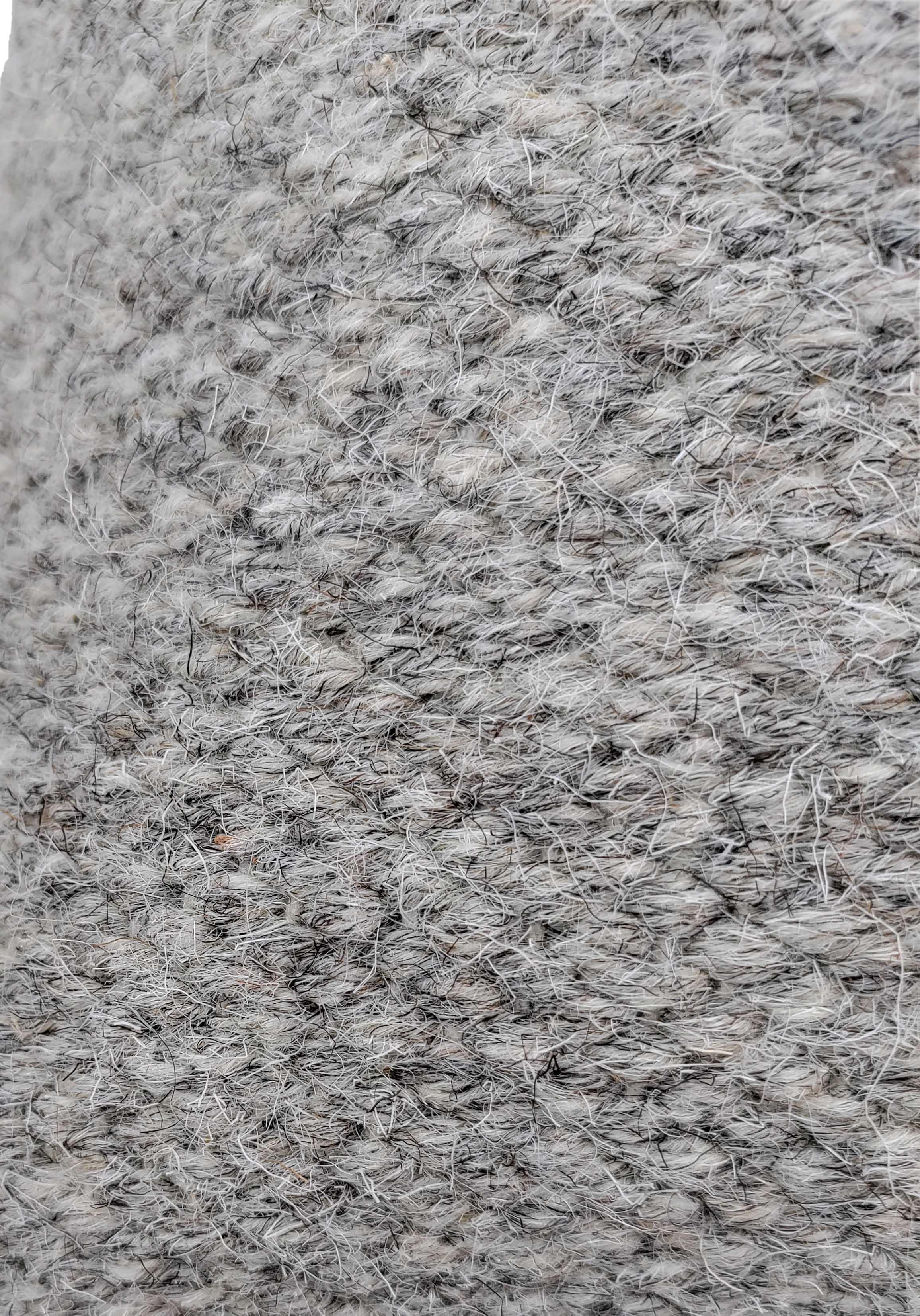 Close-up of the textured gray Wool Cushion With Insert cs-142 by RAMSHA HOME, featuring visible fibers and a slightly rough surface. The detailed weave and yarn strands add style to any home decor.