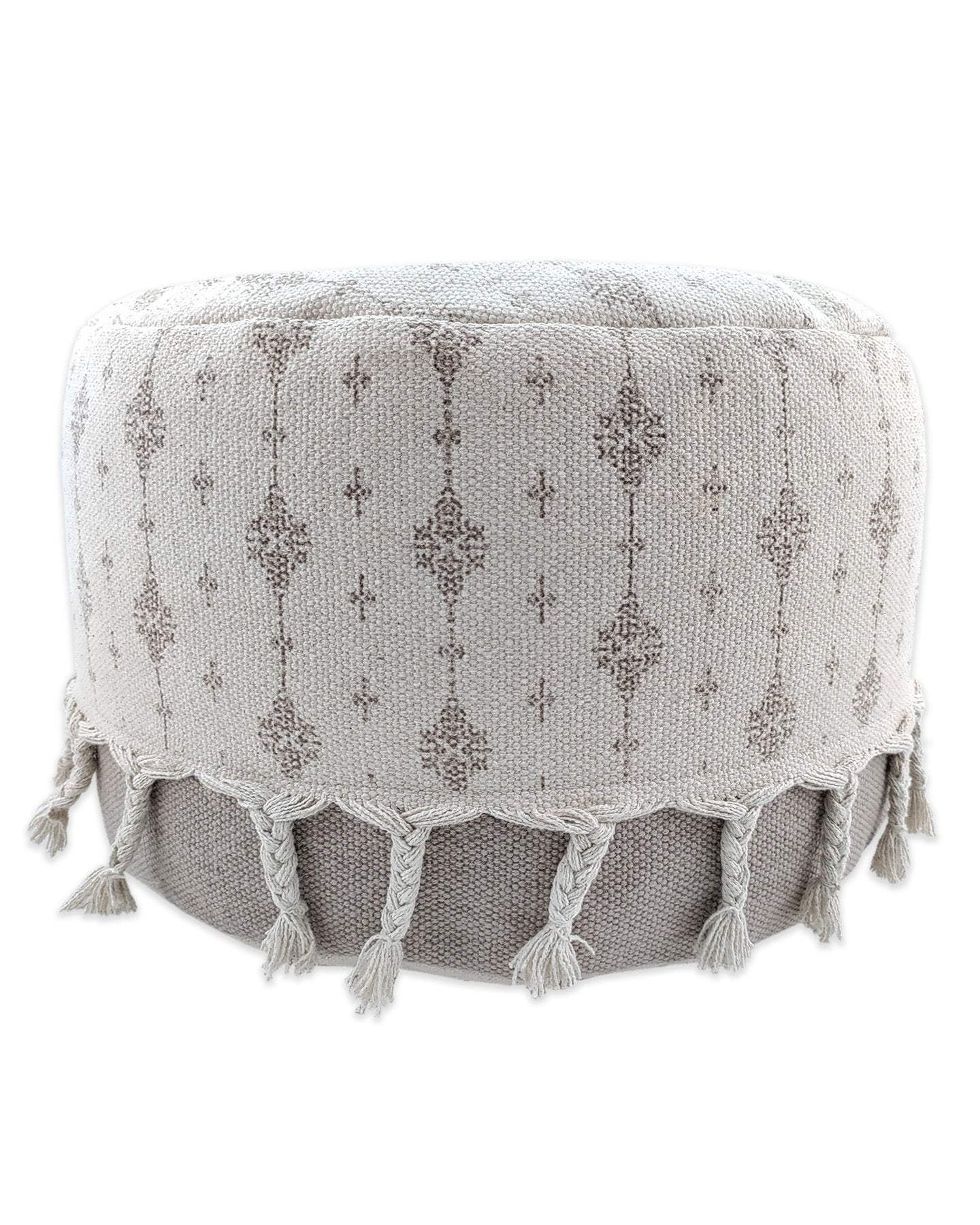 White and grey handwoven cotton pouf with fringes, a modern decorative seating accent for living spaces.
