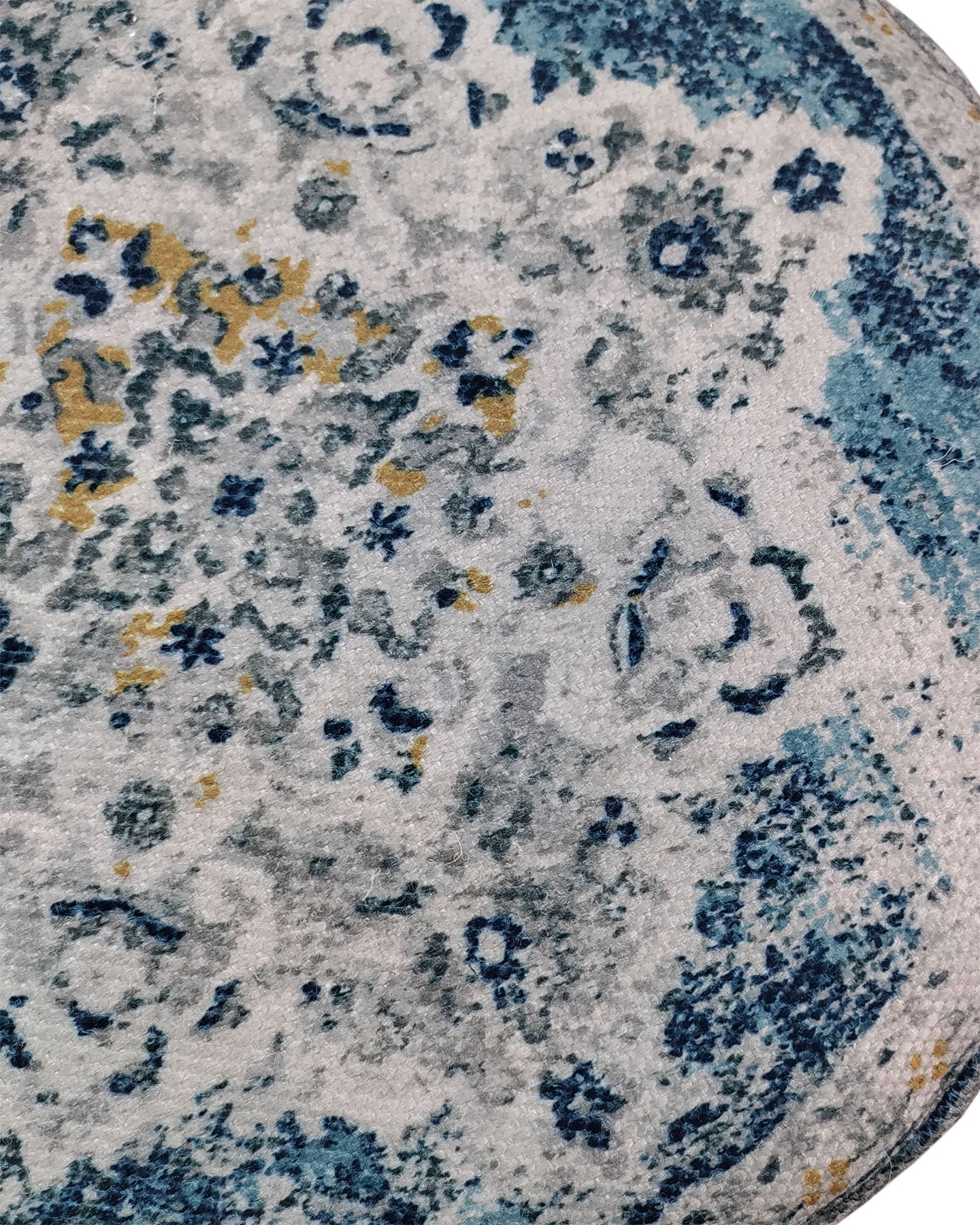 A close-up of a vintage-style, distressed rug in blue, gray, white, and yellow pairs perfectly with the RAMSHA HOME Multi Color Pouf With Leather Handle PF-079 for added comfort and style.