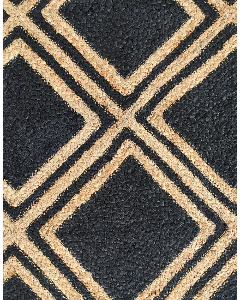 Close-up of RAMSHA HOME's Handmade Natural & Black Color Braided Jute Rug (BR 038), showing a textured surface with black and tan diamond patterns outlined by thick tan lines.