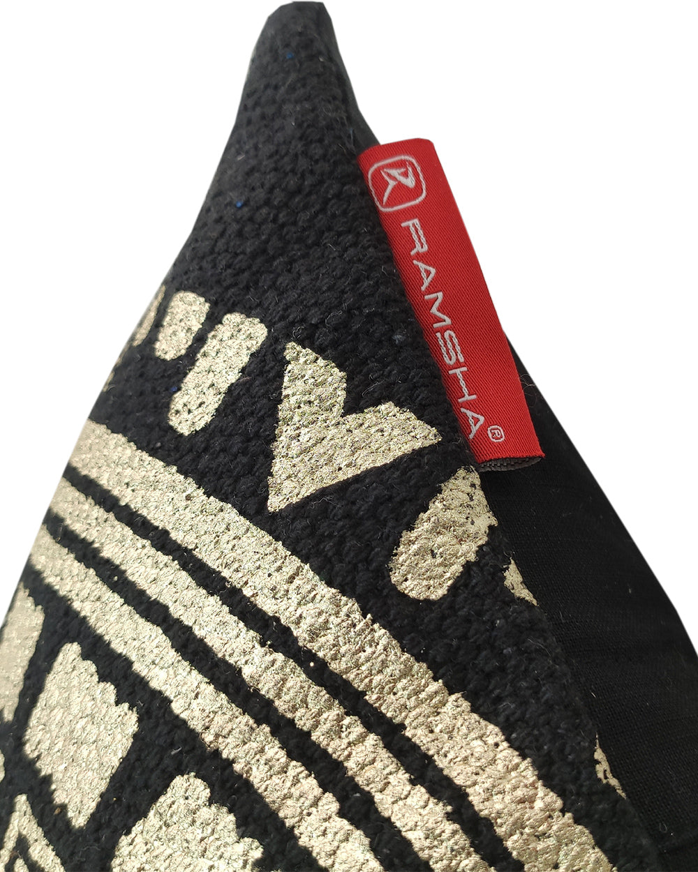 Close-up of the Gold And Black Foil Printed Cushion CS-196 by RAMSHA HOME, showcasing textured patterns and a red fabric tag labeled RAMSHA® on the seam.